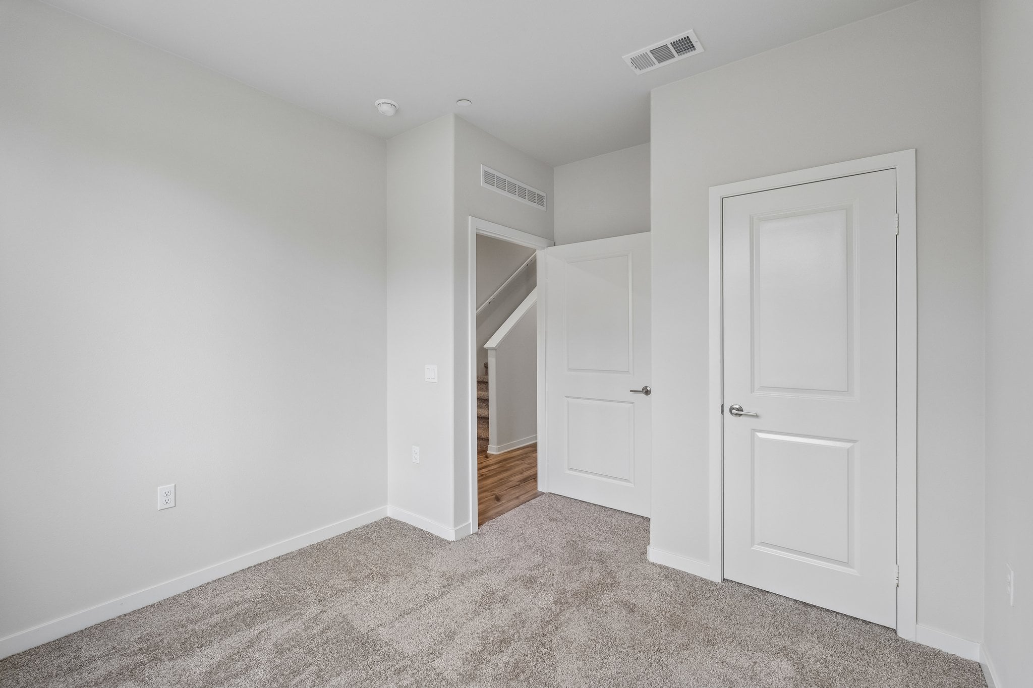 A hallway with white doors.