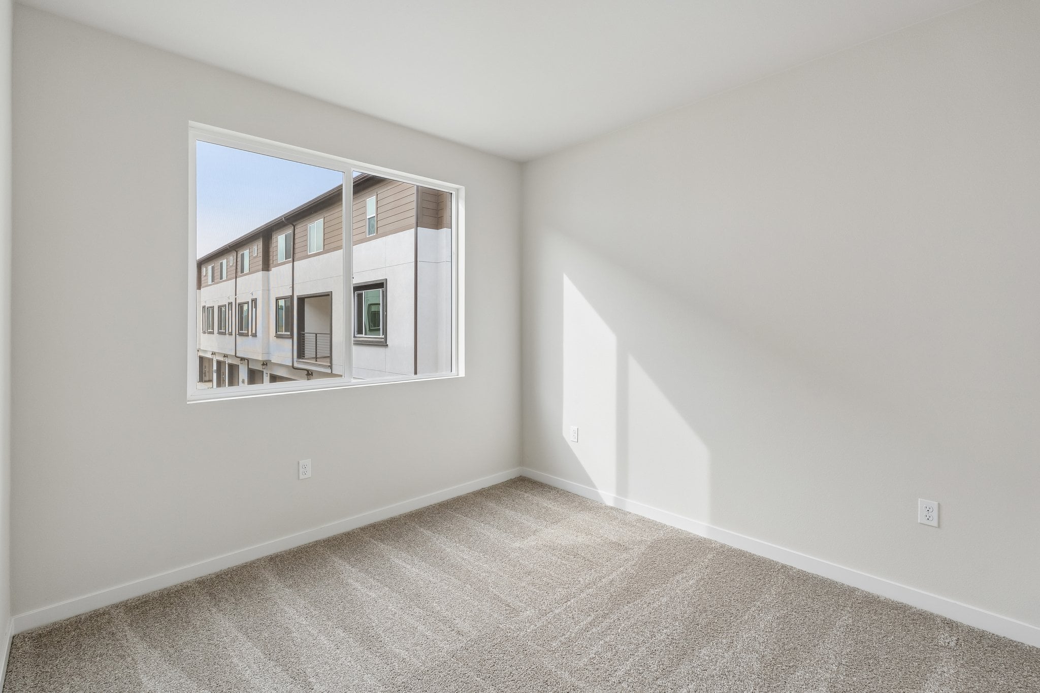 A white room with a window.