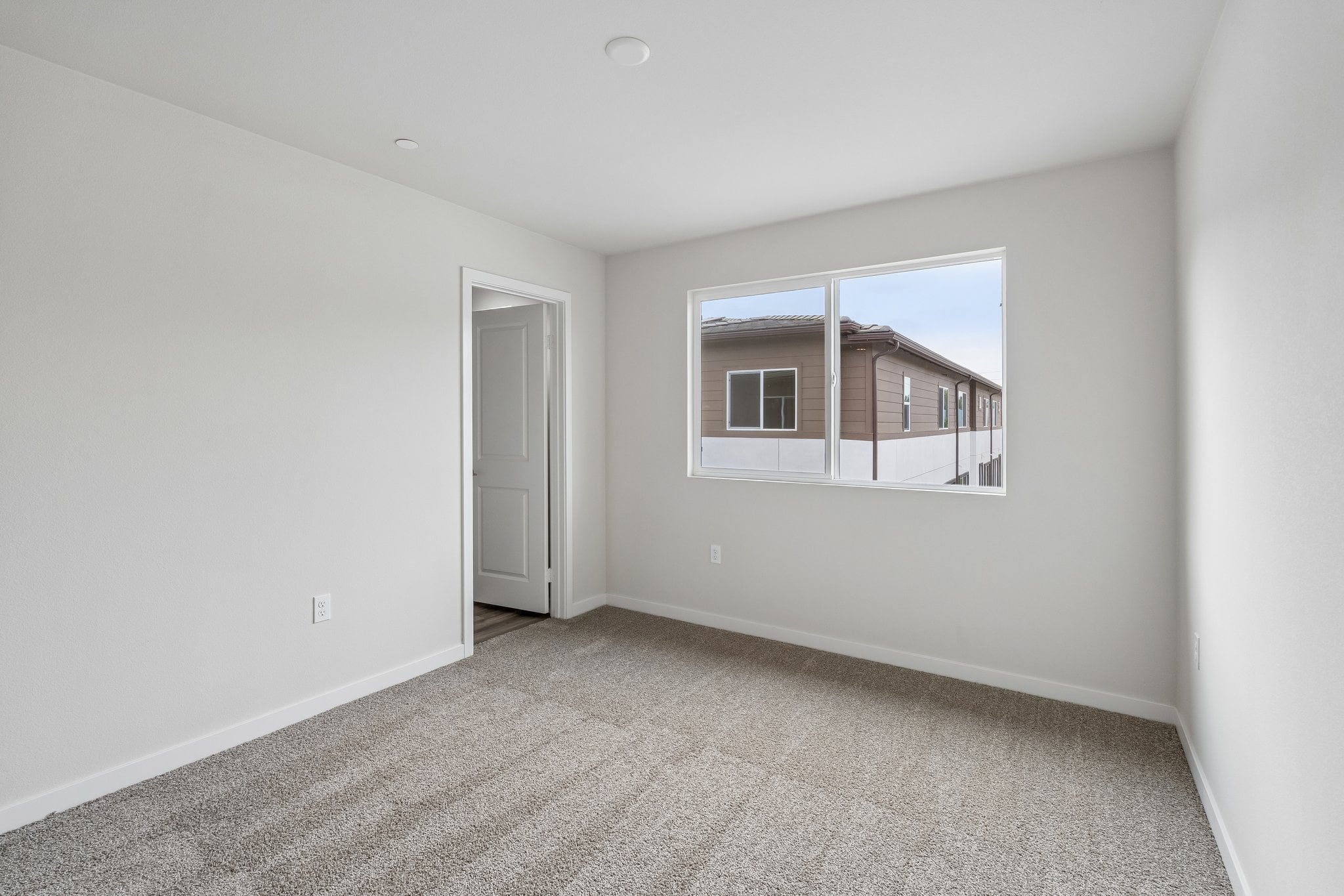A room with a window and a door.