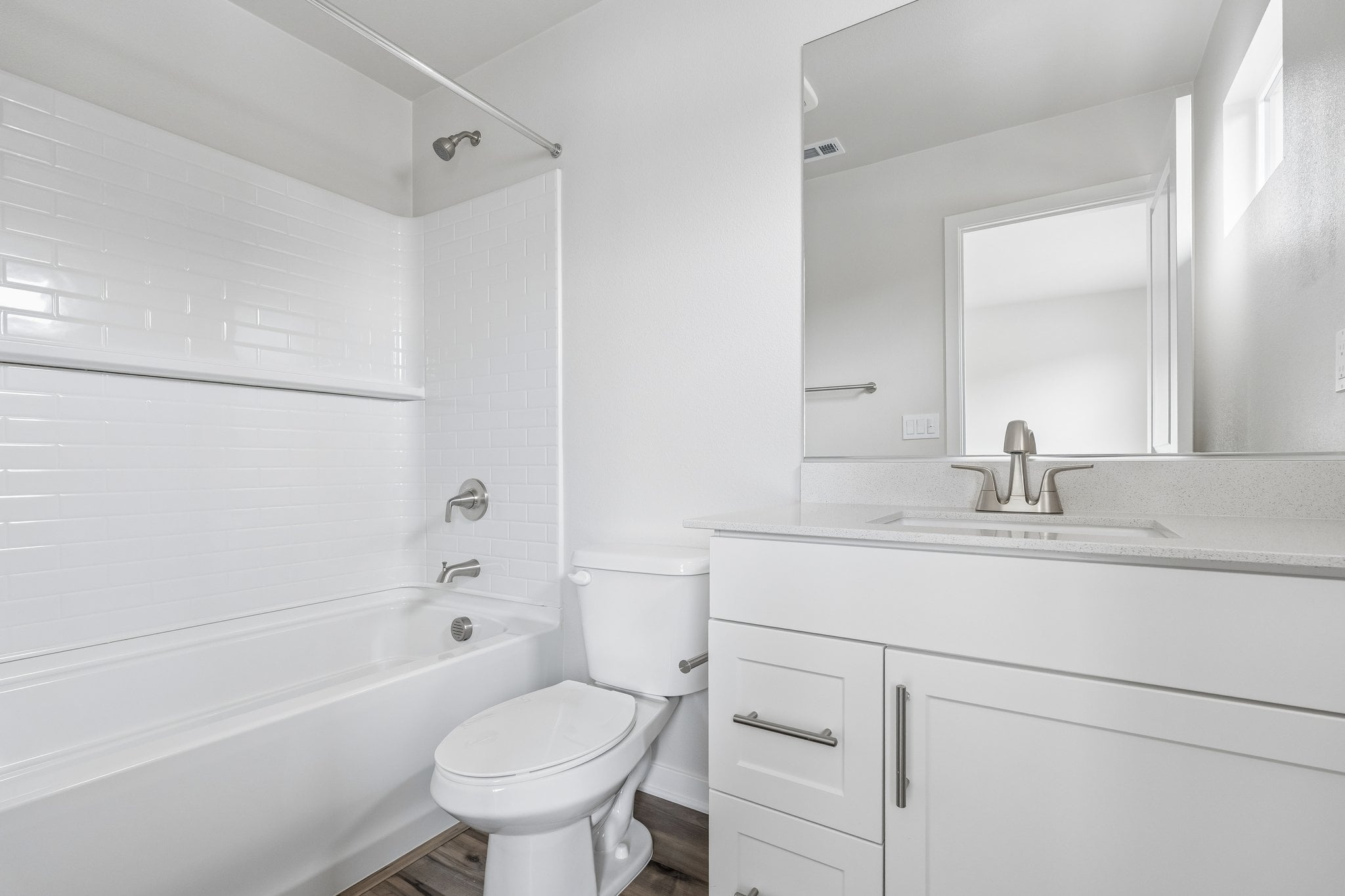 A bathroom with a tub toilet and sink.