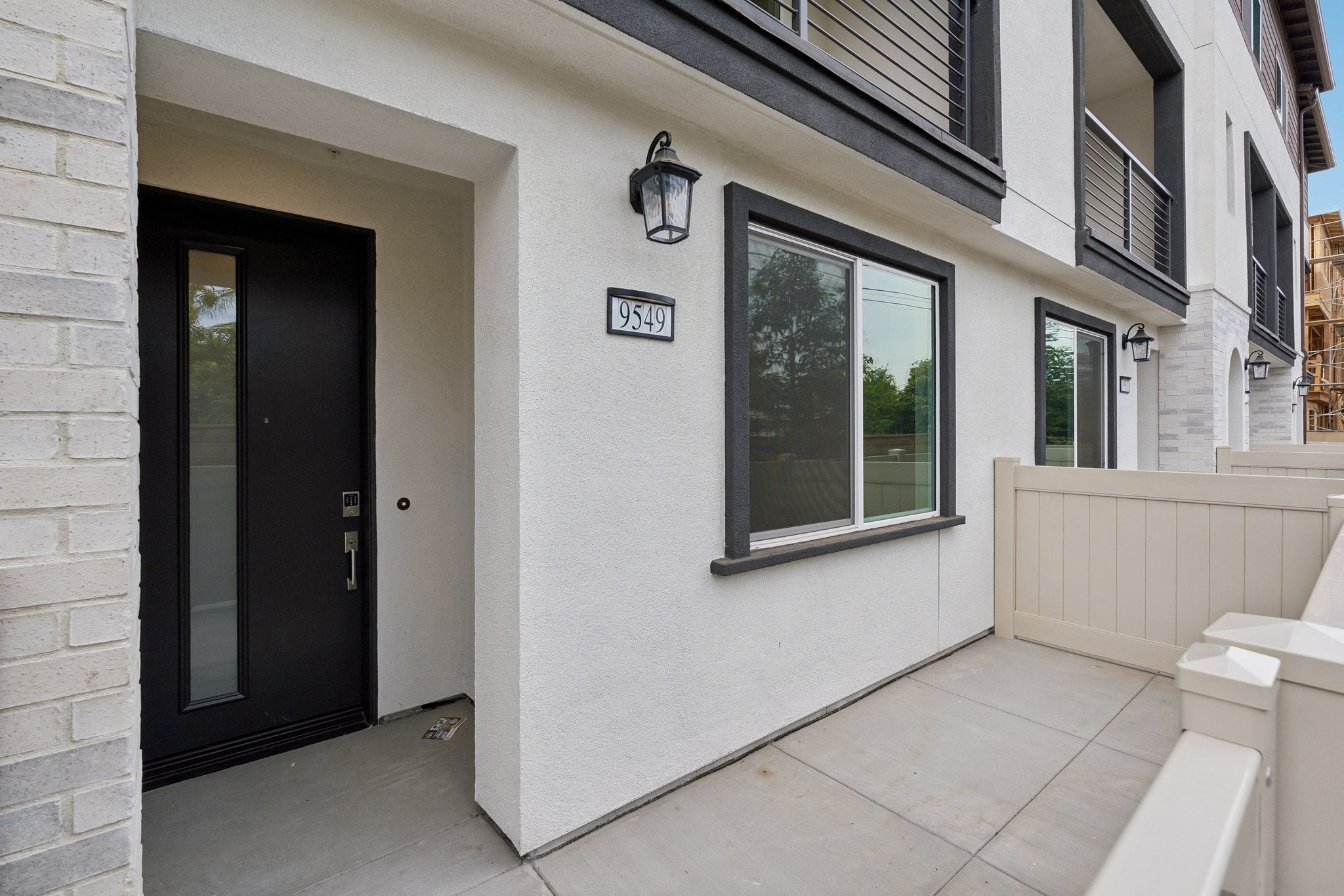 A white building with a black door.