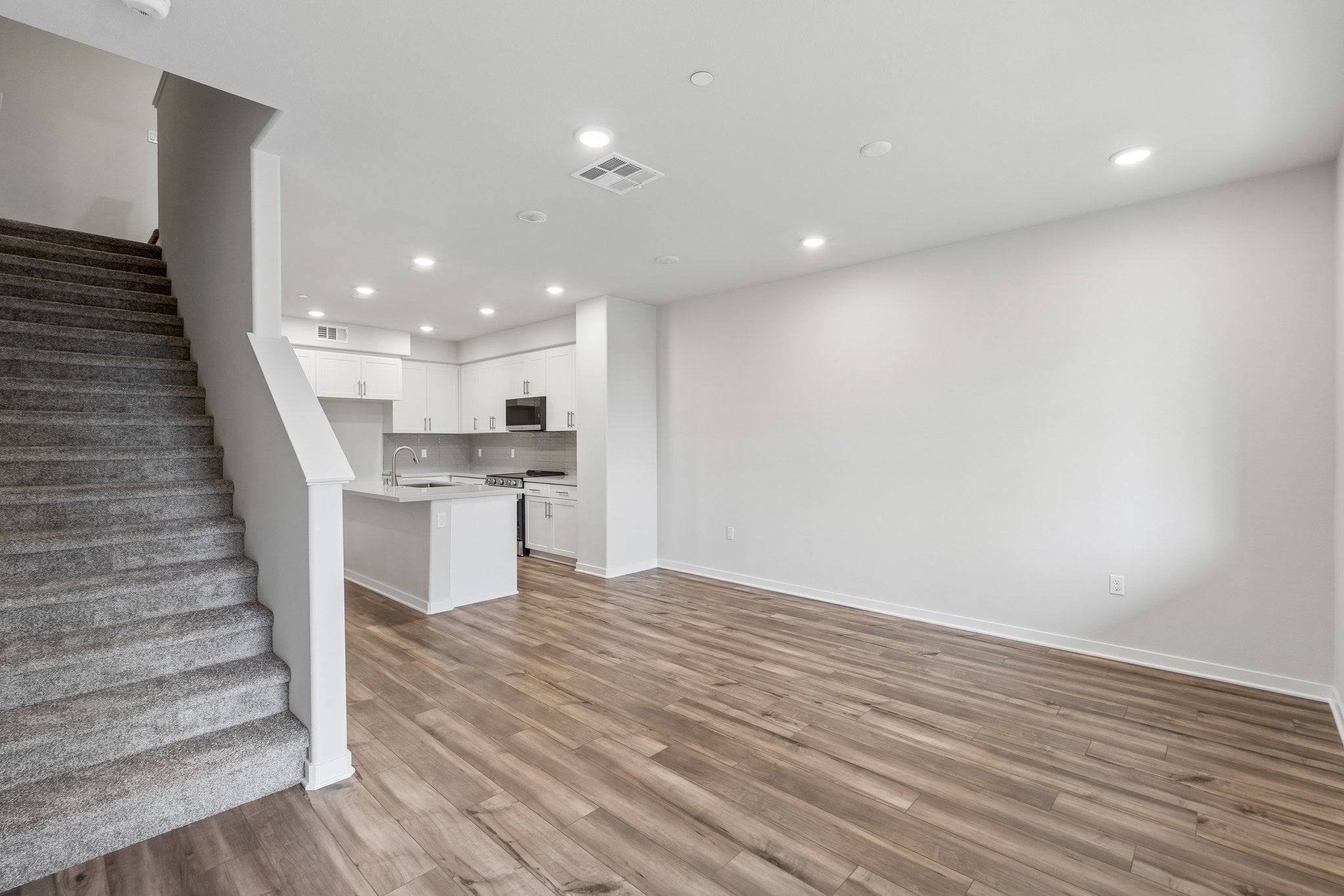 A kitchen with wooden floors.