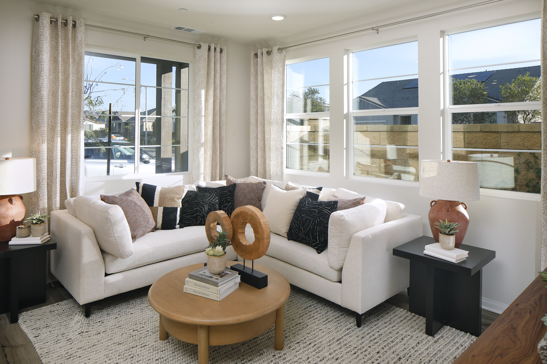 A living room with a white couch and a coffee table.