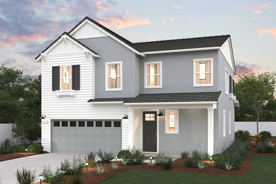 A white house with a garage.