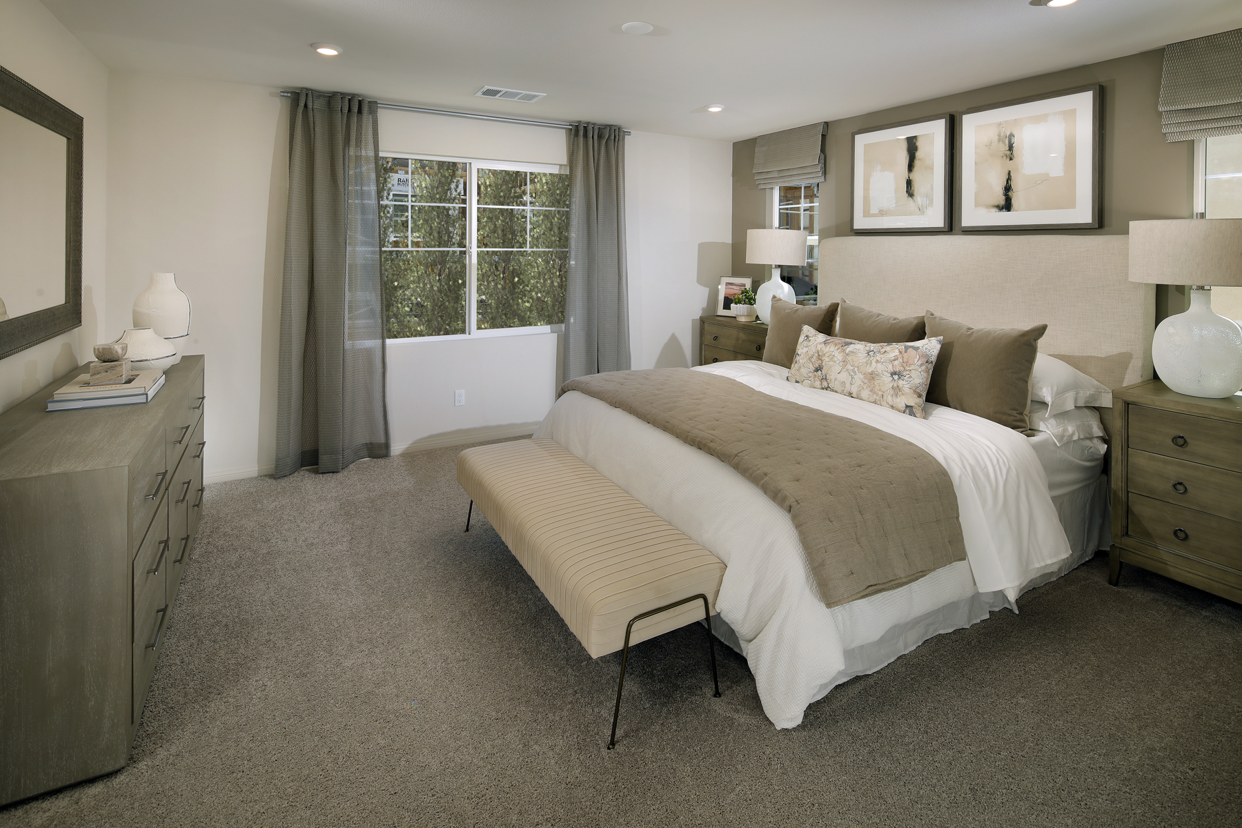 A large bedroom with a bed and a dresser.