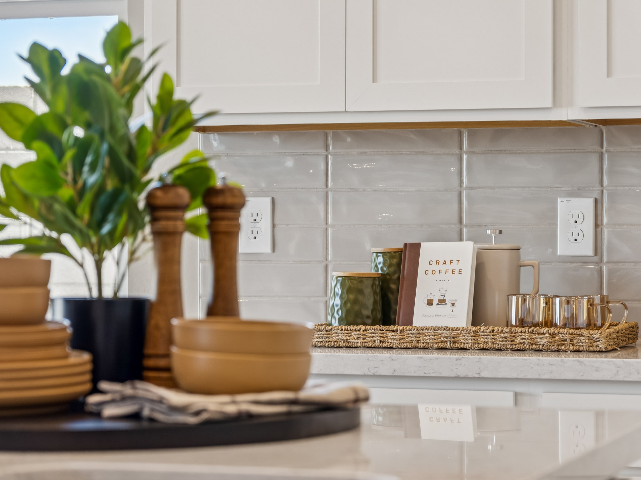 Kitchen with backsplash& white counters and white cabinets in the lanner floor plan with a built in desk and cabinets North Copper Canyon Vistas II Collection new construction homes for sale in surprise az find your dream home