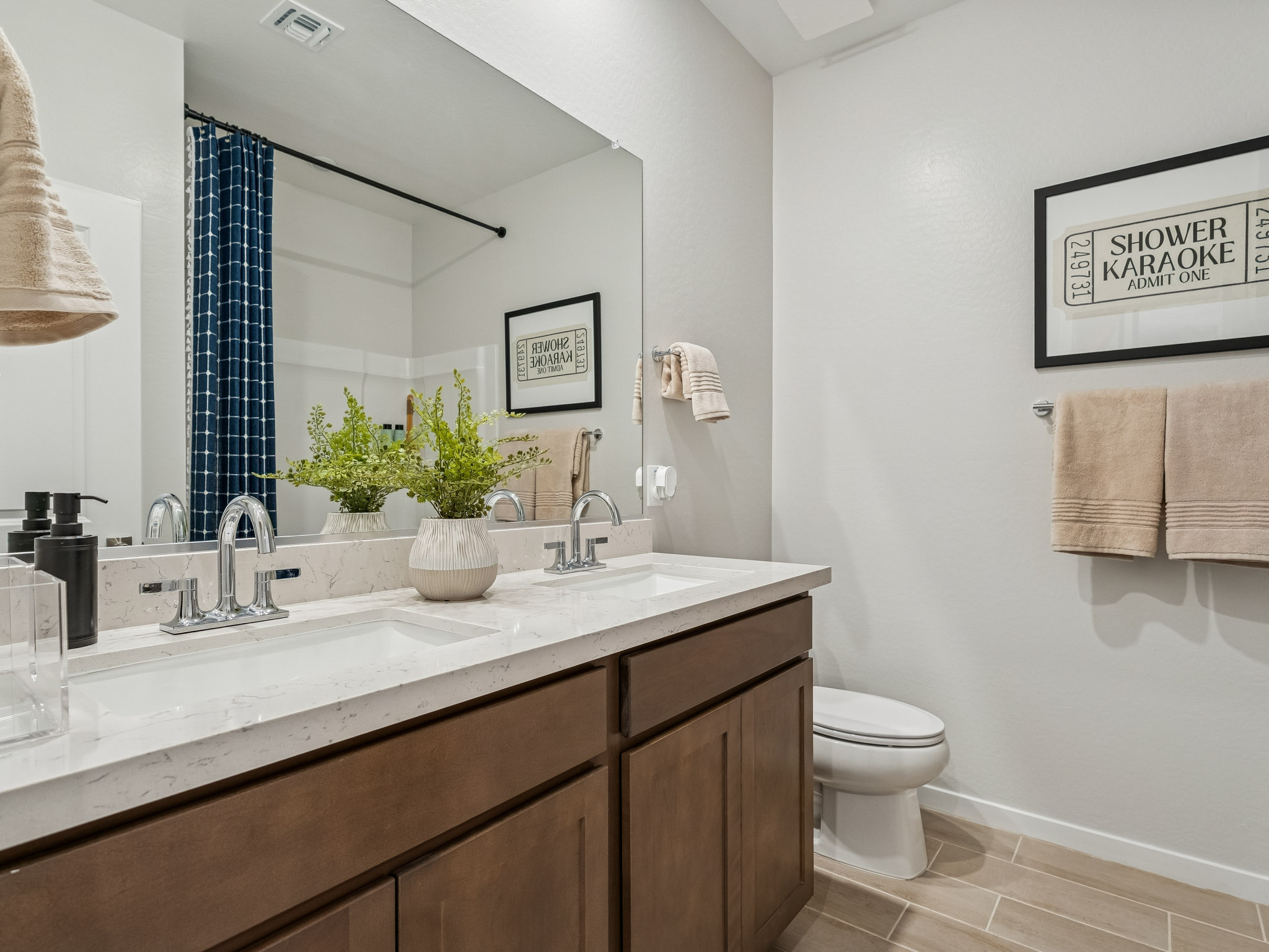 A bathroom with a large mirror.