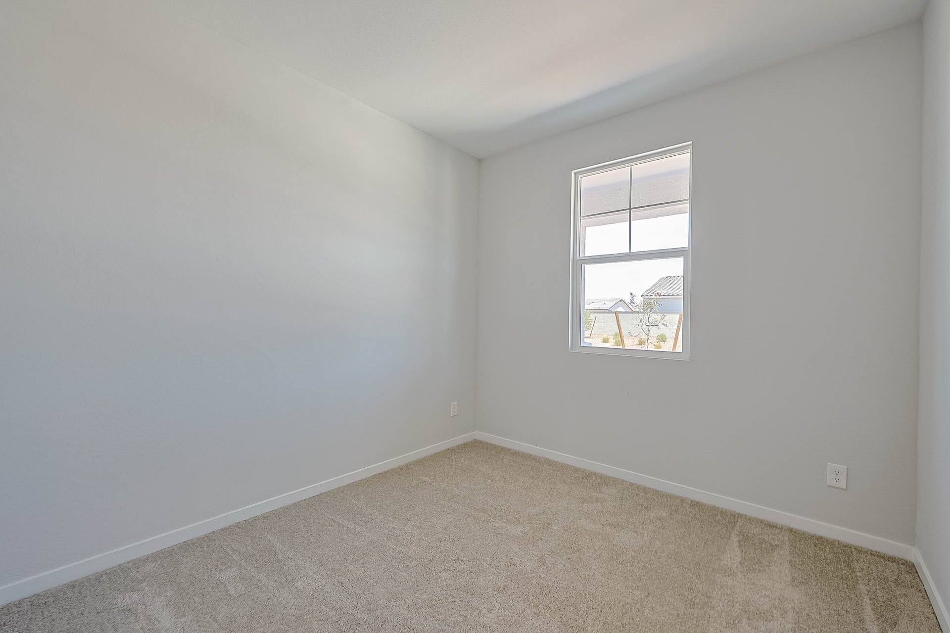 A room with a window and a carpet.