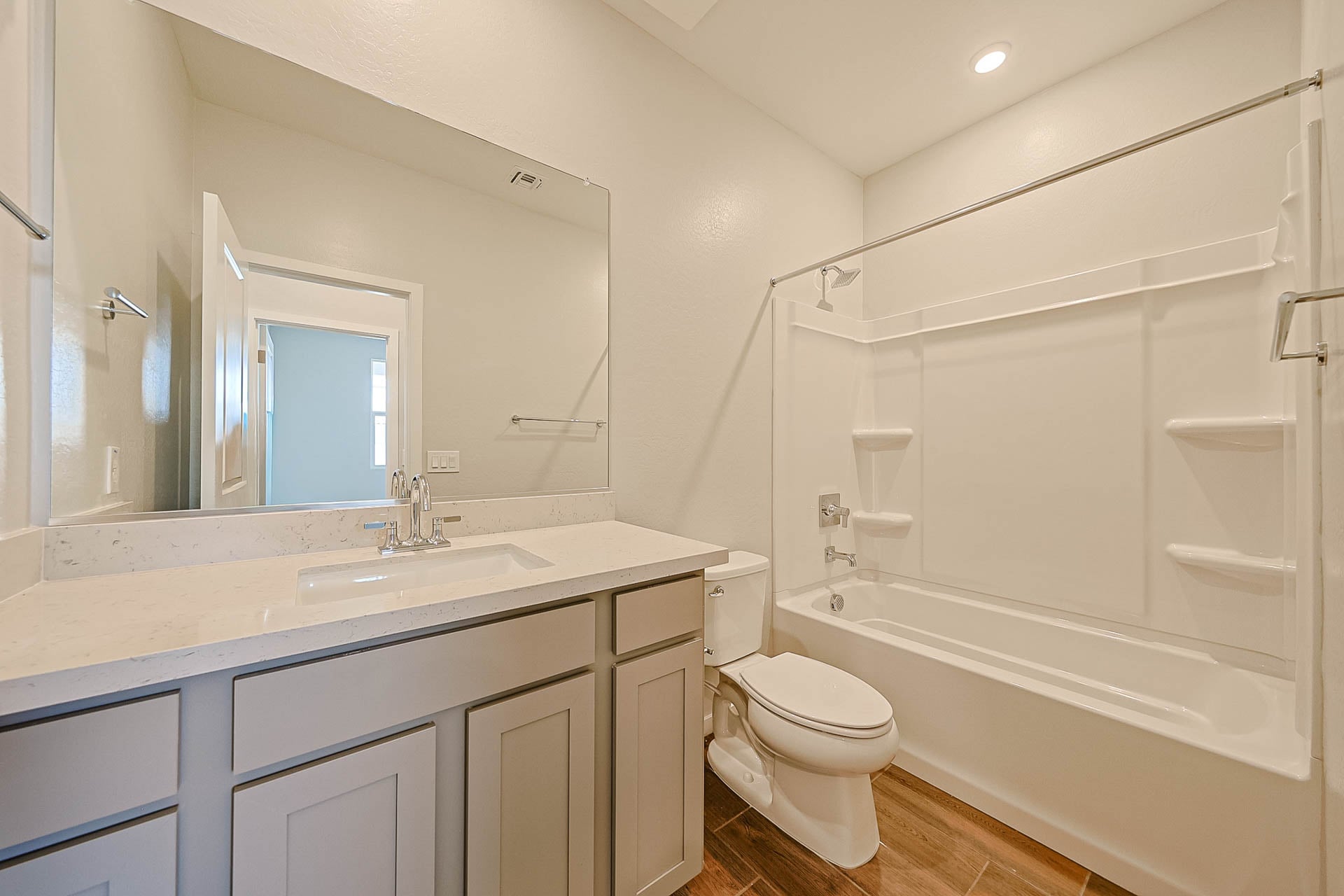 A bathroom with a tub sink and toilet.