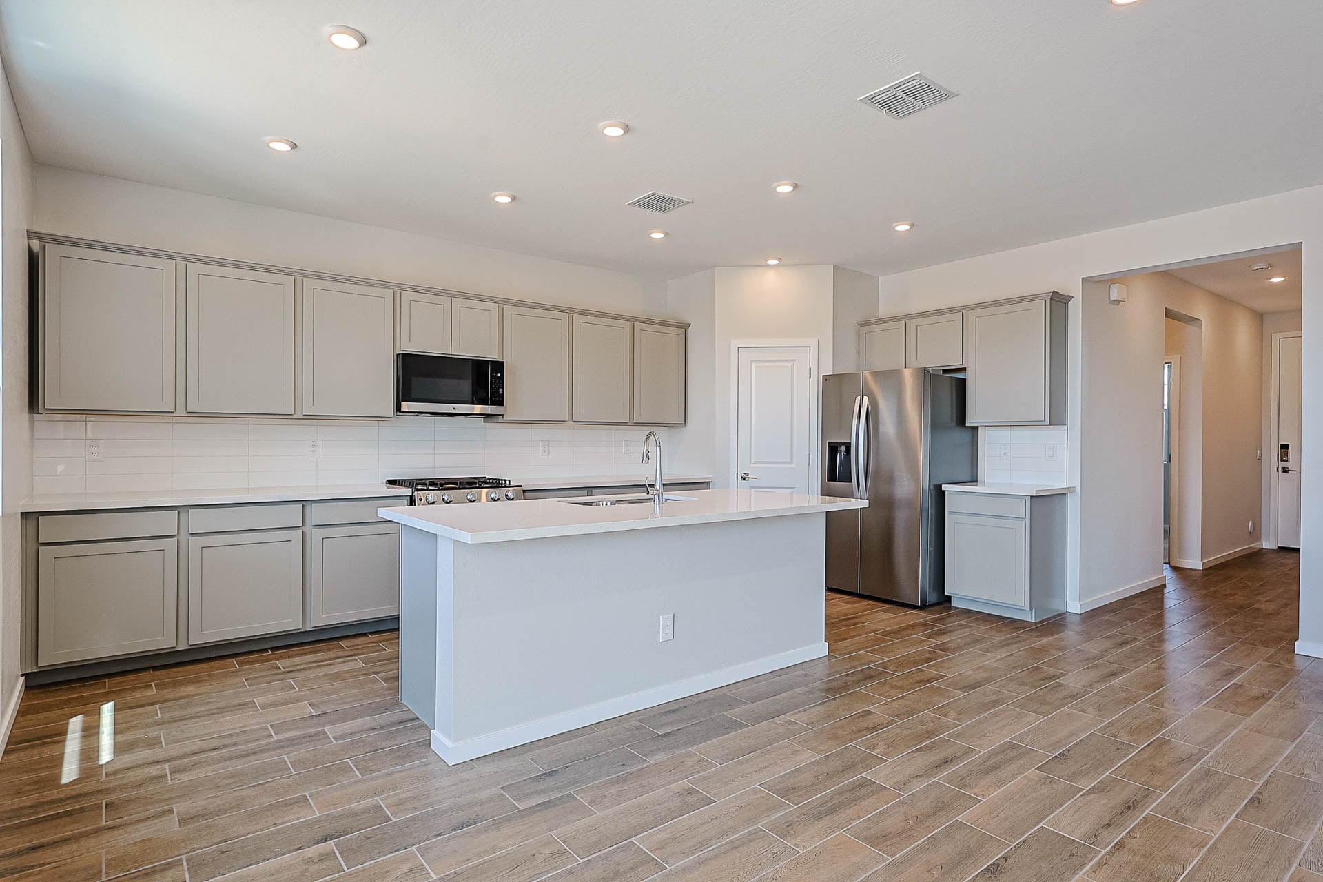A kitchen with white cabinets.