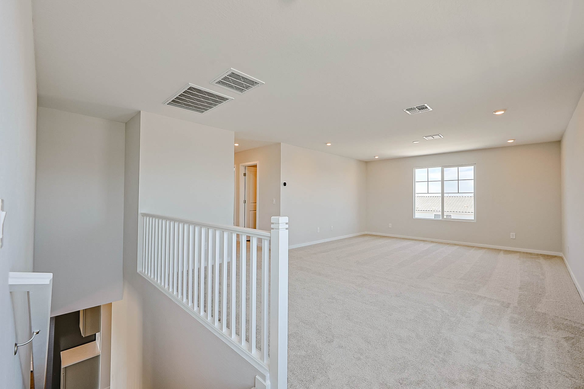 A room with a white railing and a white railing.