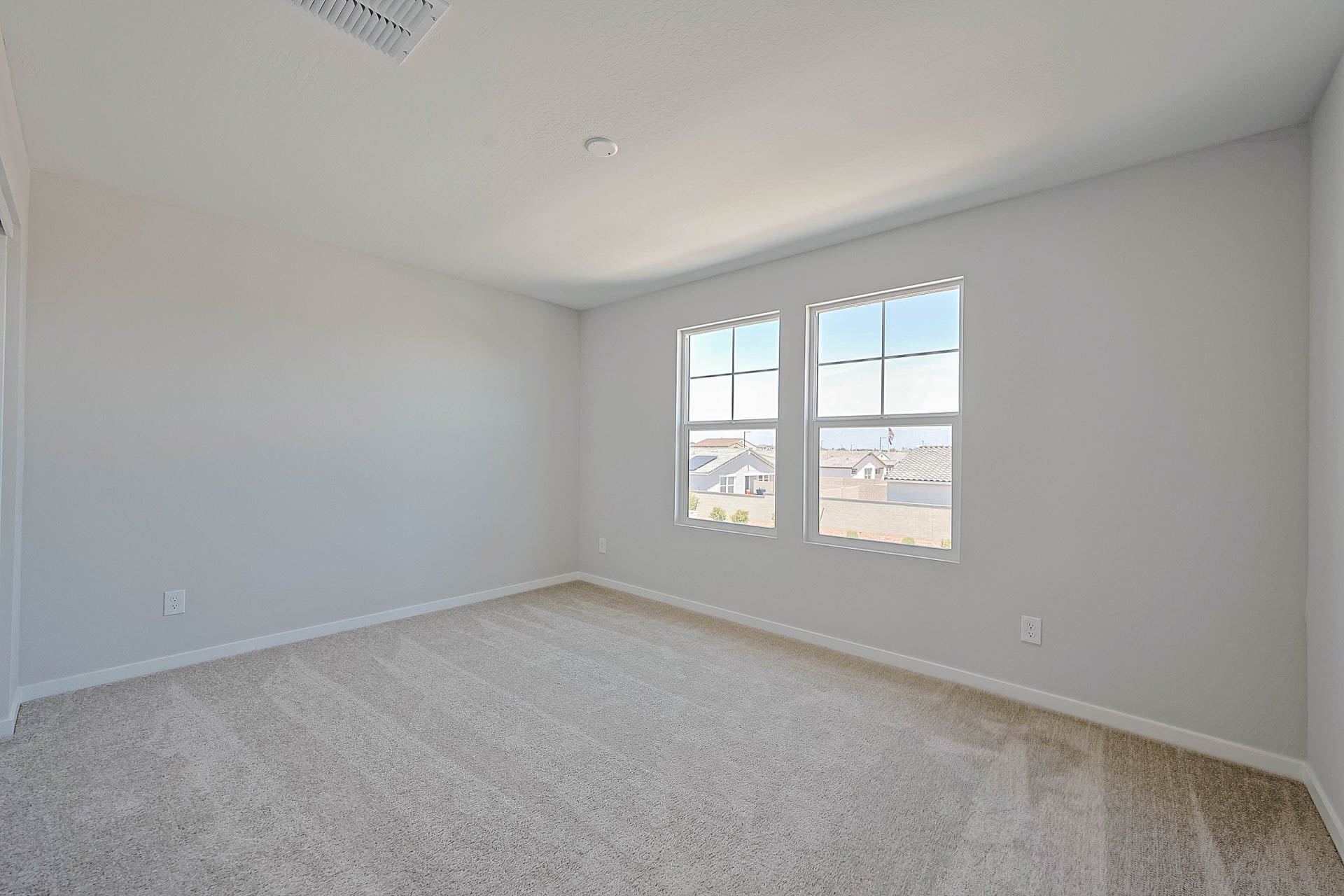A room with a window and a carpet.