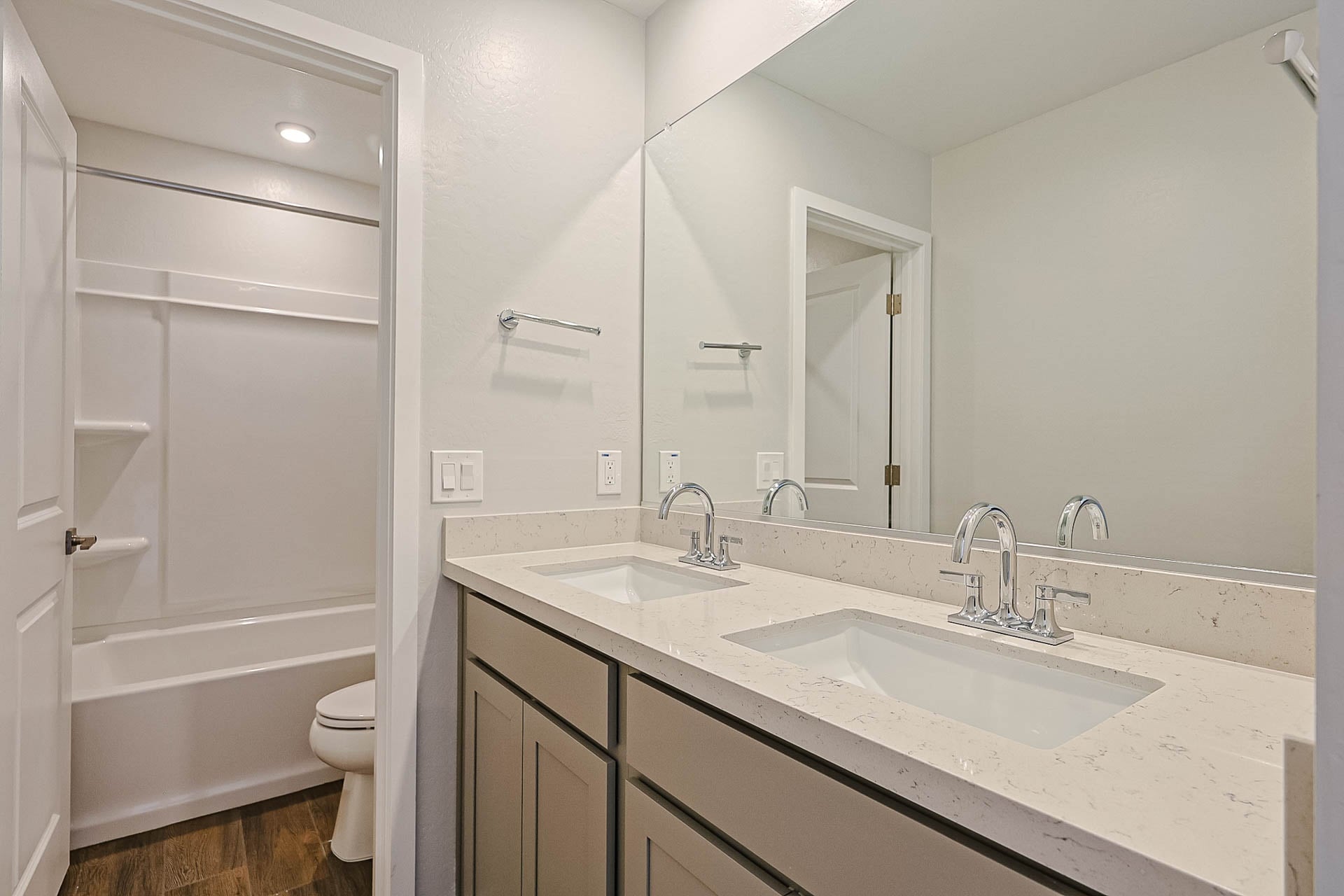 A bathroom with a sink toilet and bathtub.