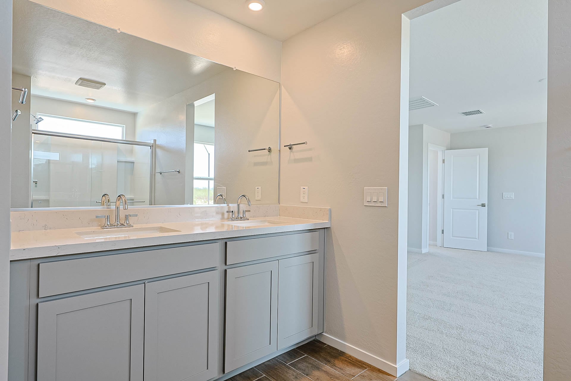 A bathroom with white cabinets.