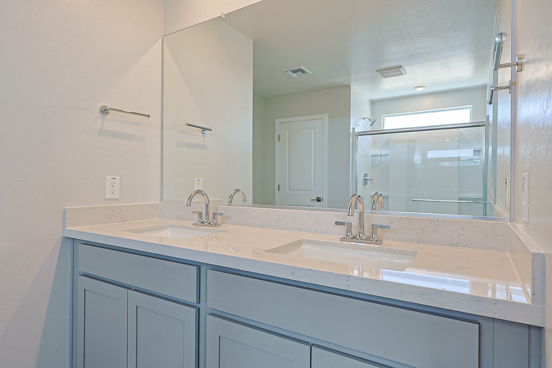 A bathroom with sinks and mirrors.