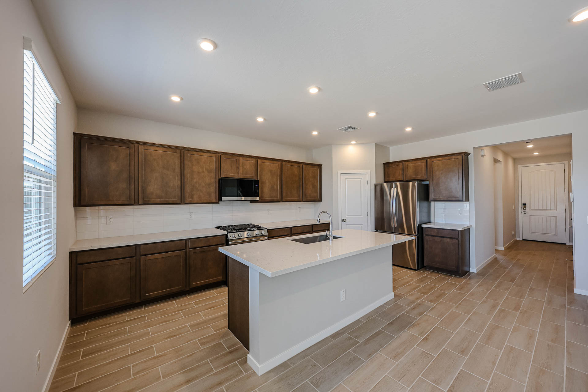 A kitchen with wooden cabinets.