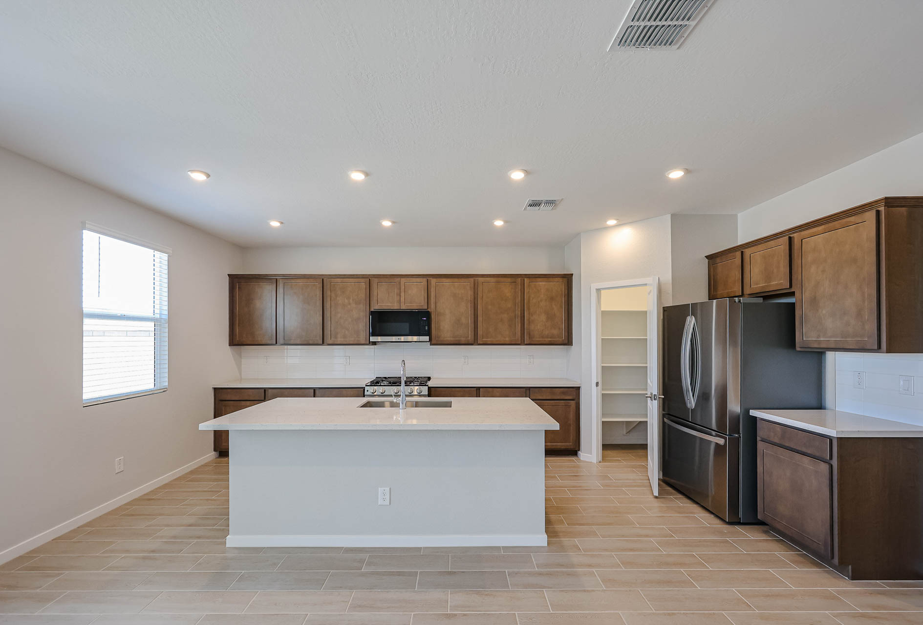 A kitchen with wooden cabinets.