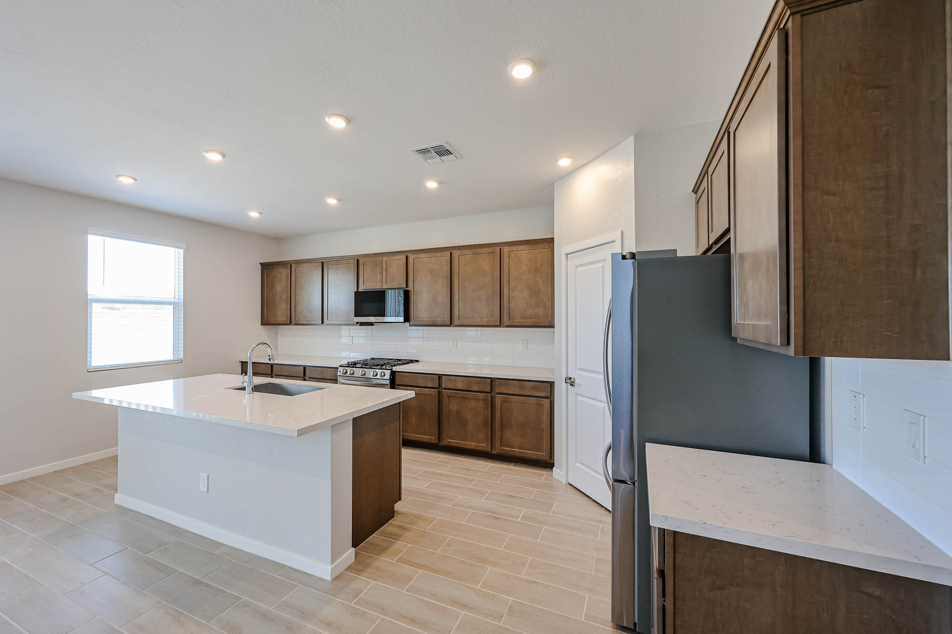 A kitchen with wooden cabinets.