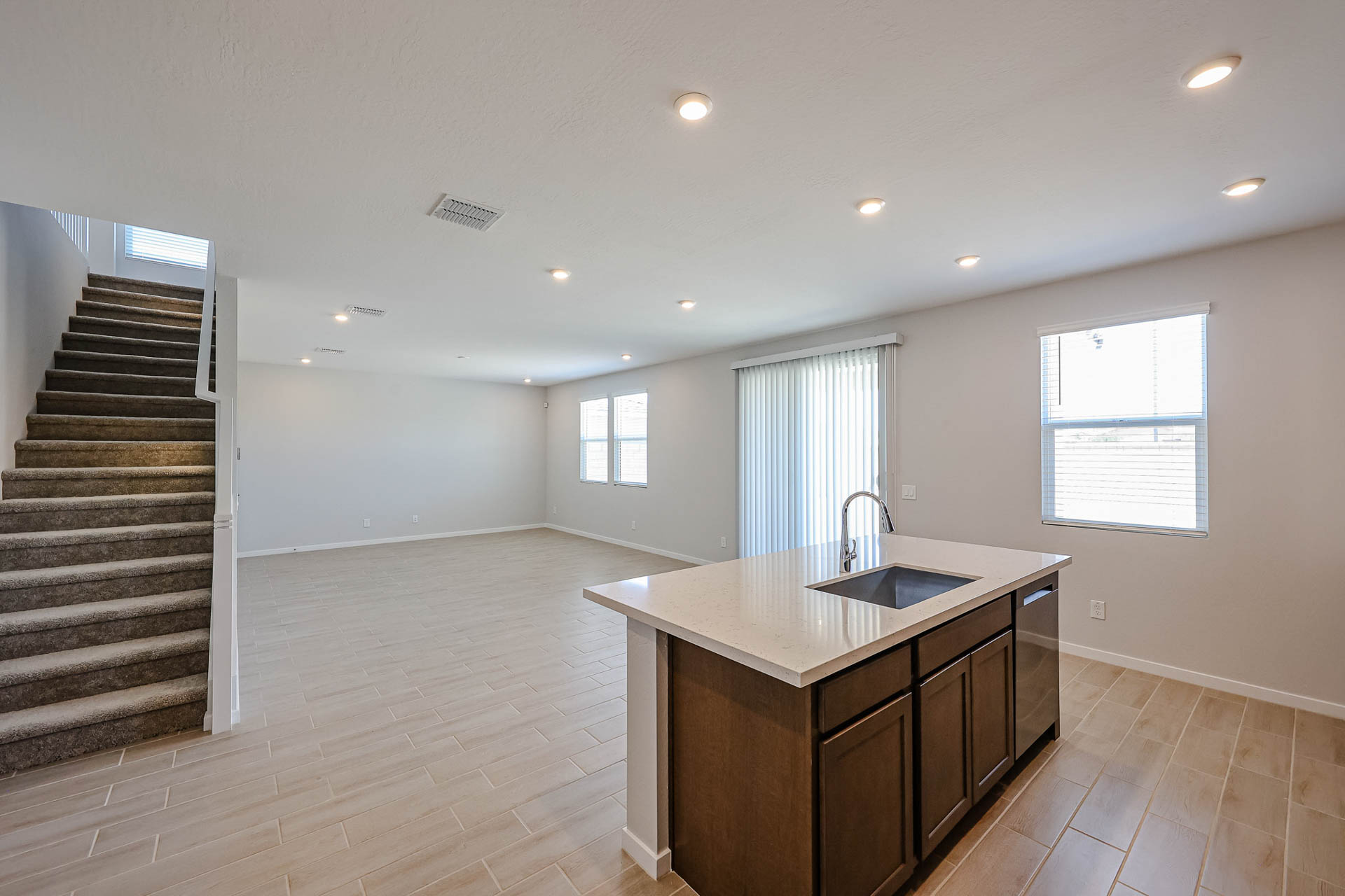 A large kitchen with a large marble countertop.