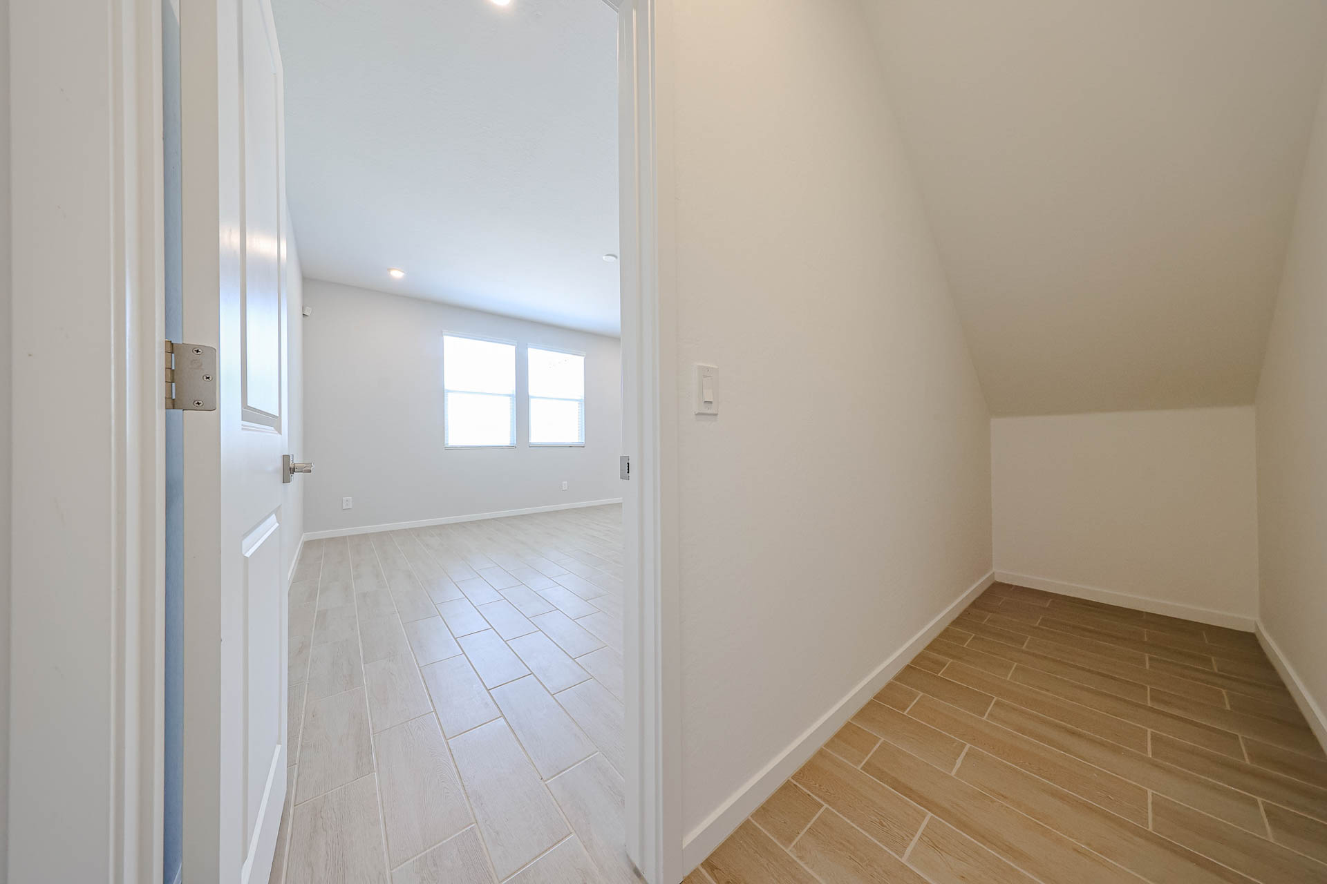 A hallway with white walls.