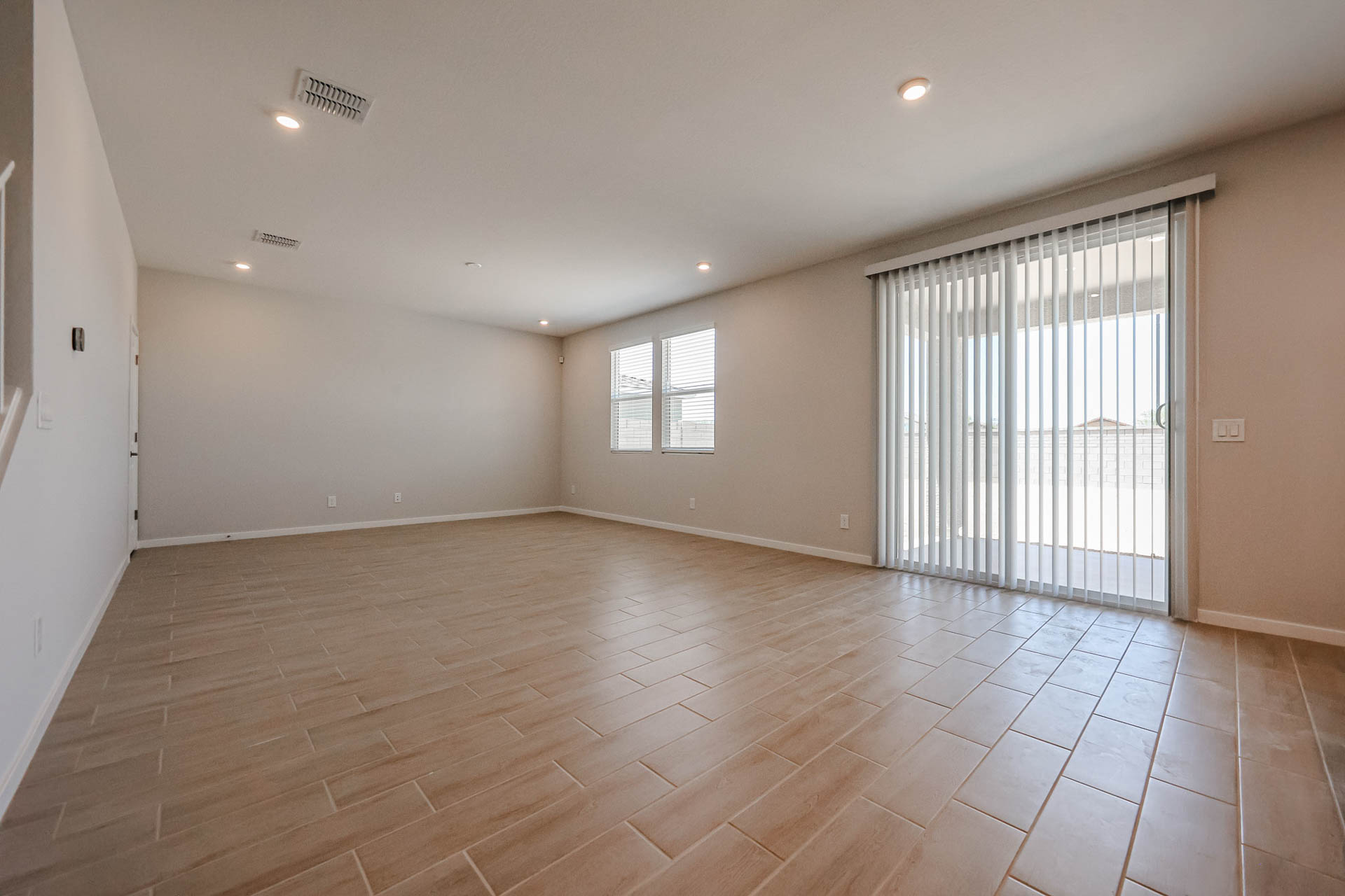 A room with a wood floor and white walls.