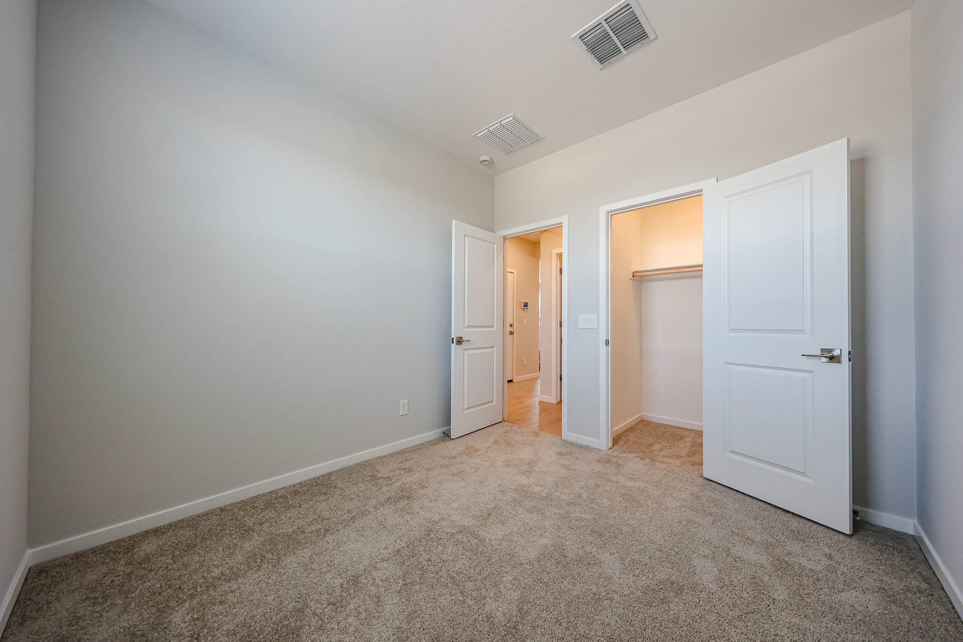 A hallway with white doors.
