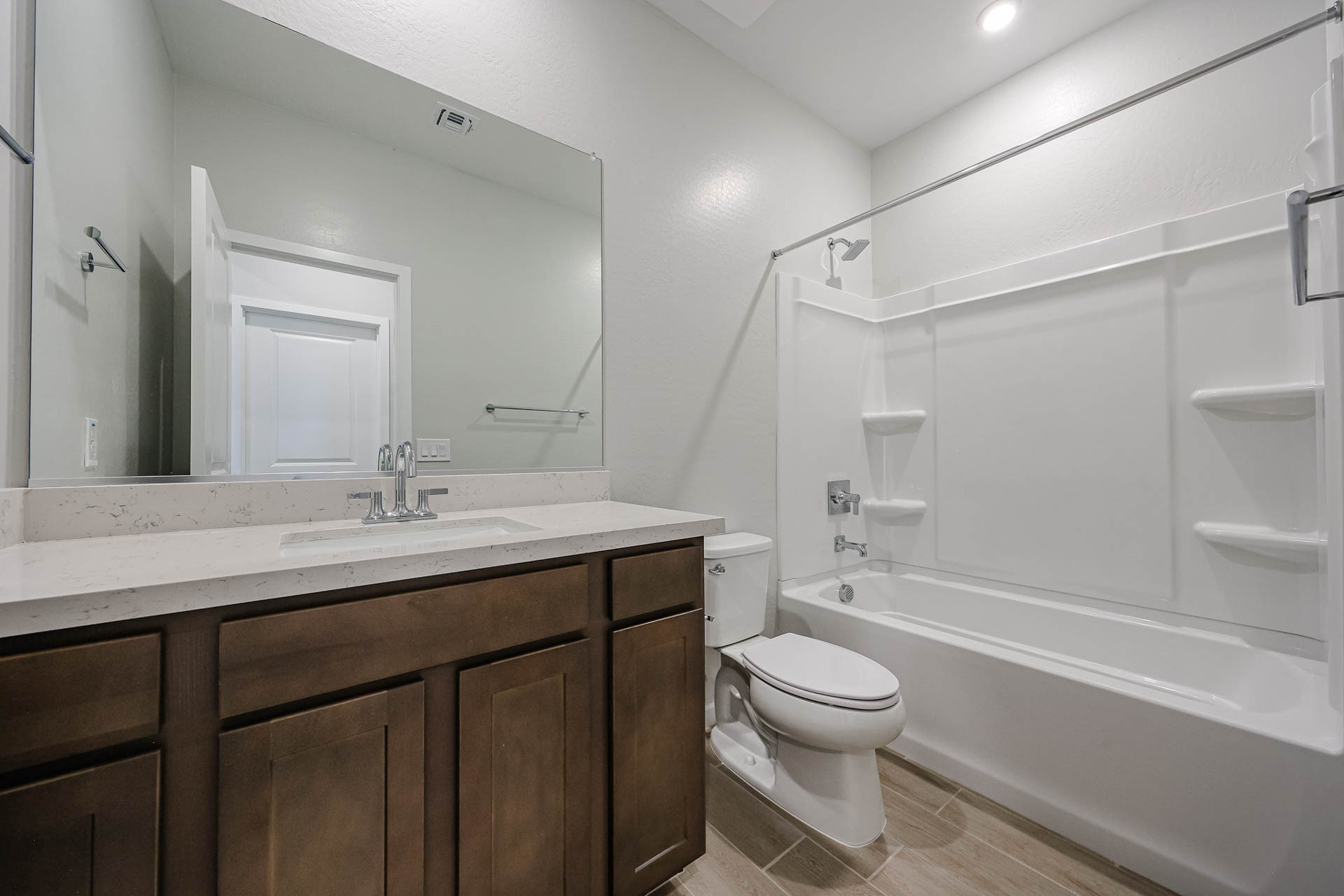 A bathroom with a tub toilet and sink.