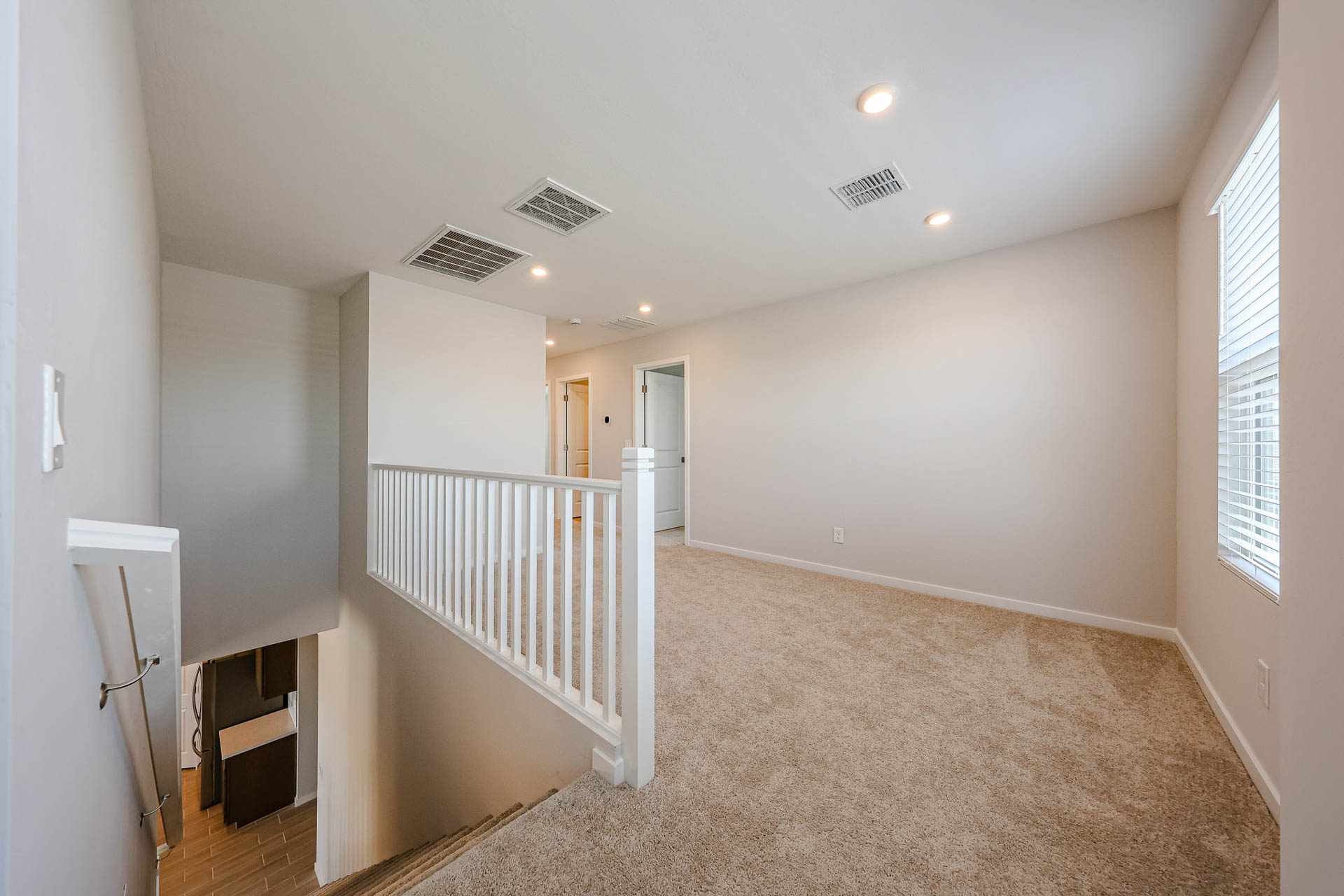 A hallway with white walls.