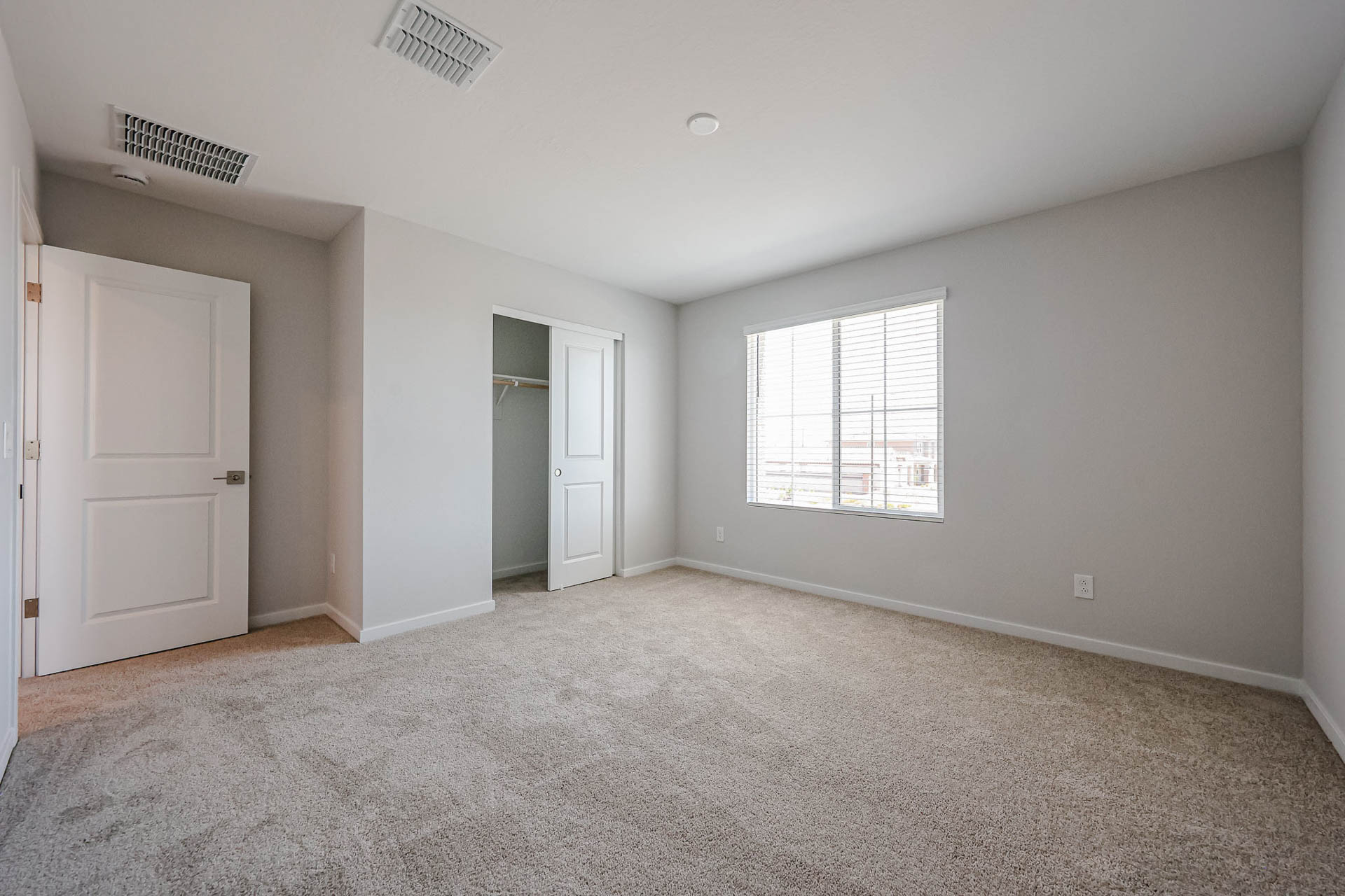 A room with white walls and a carpeted floor.