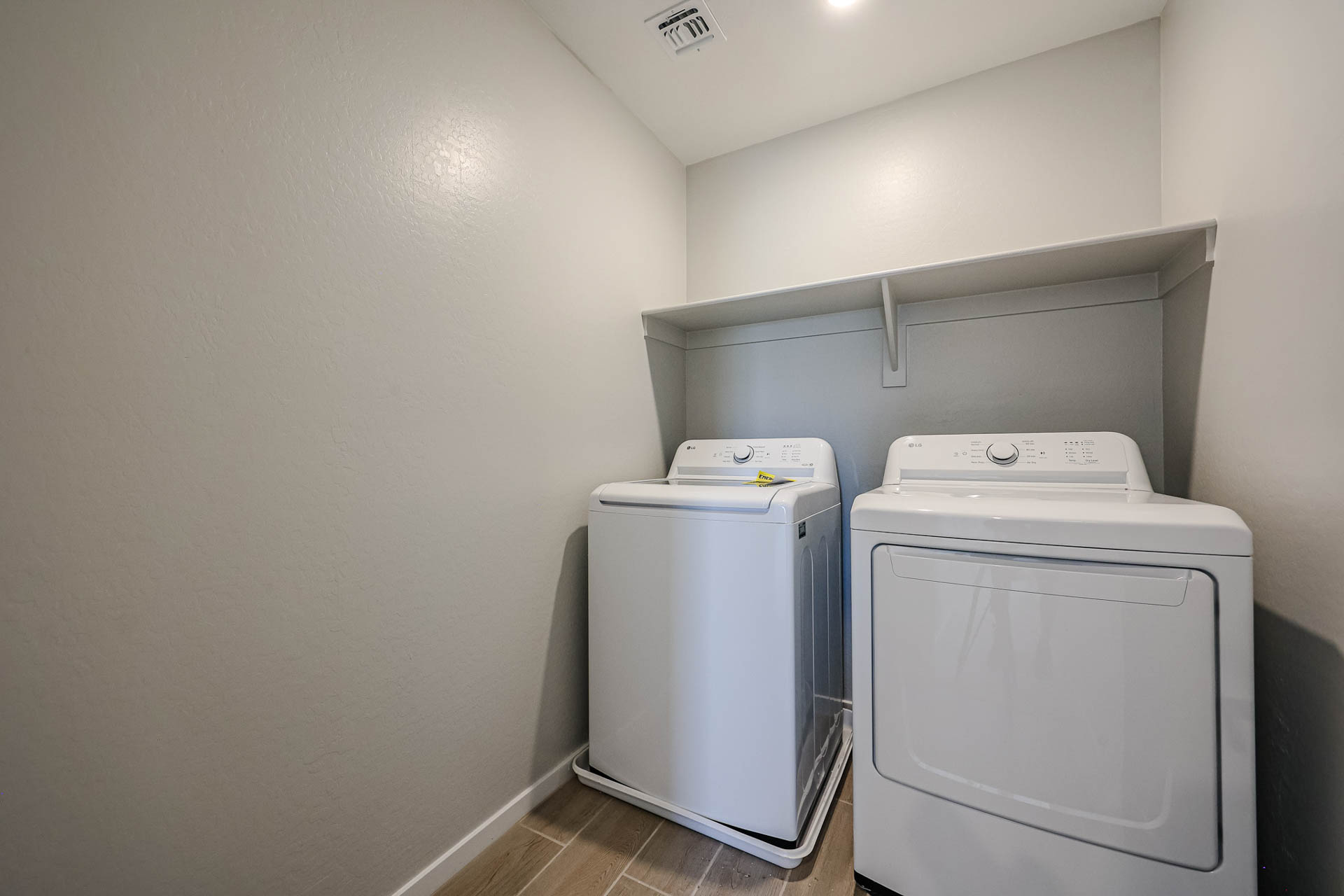 A washing machine and dryer in a room.