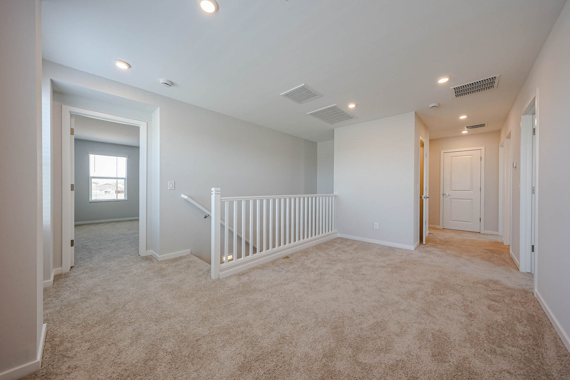 A room with a white railing and a white railing.