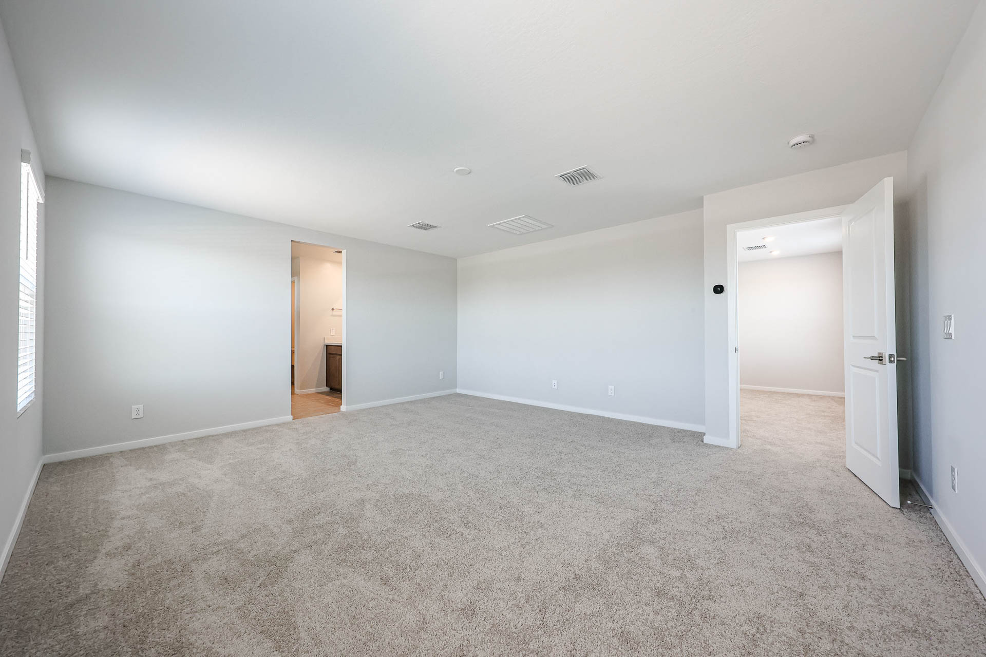 A long hallway with white doors.