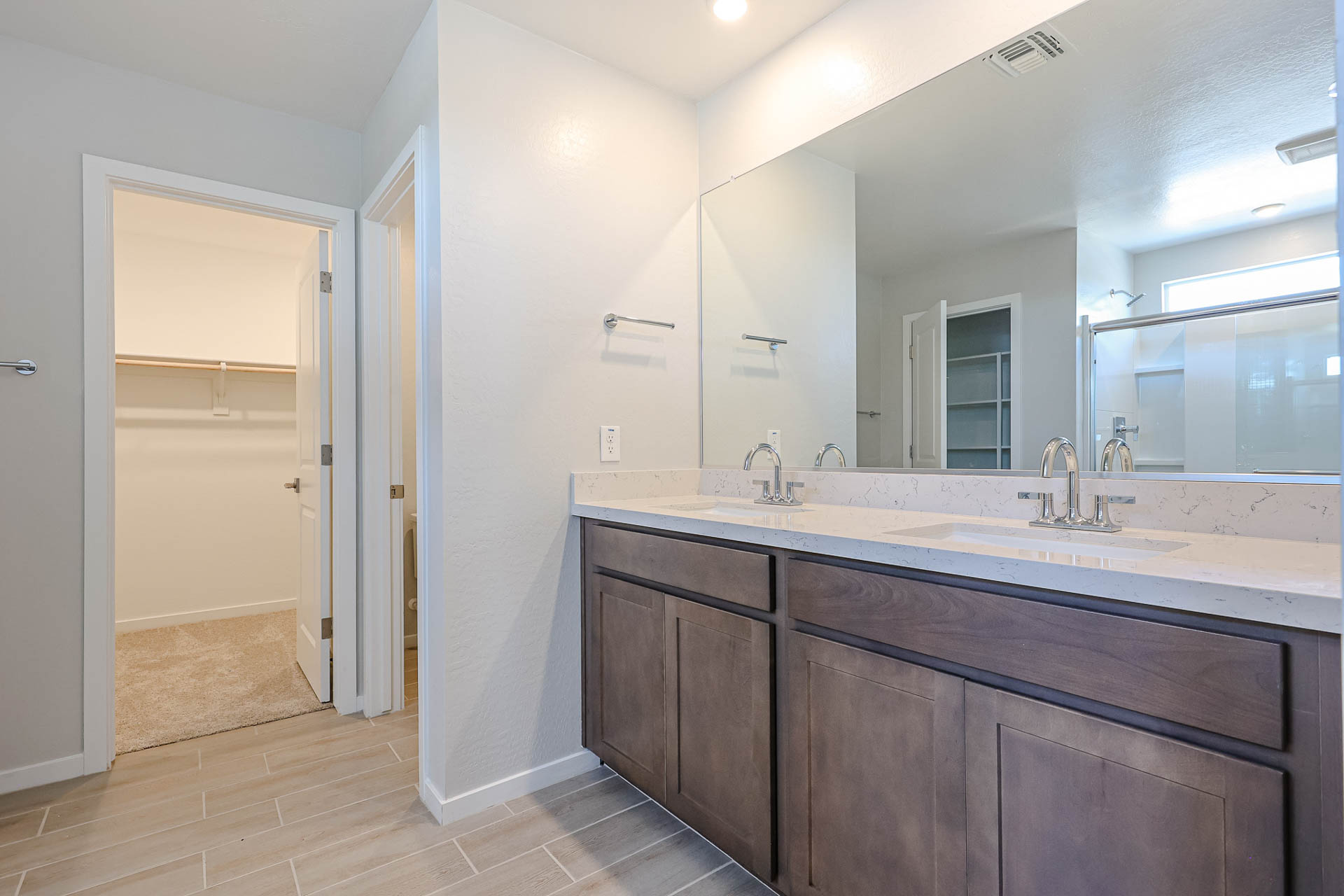 A bathroom with a large mirror.