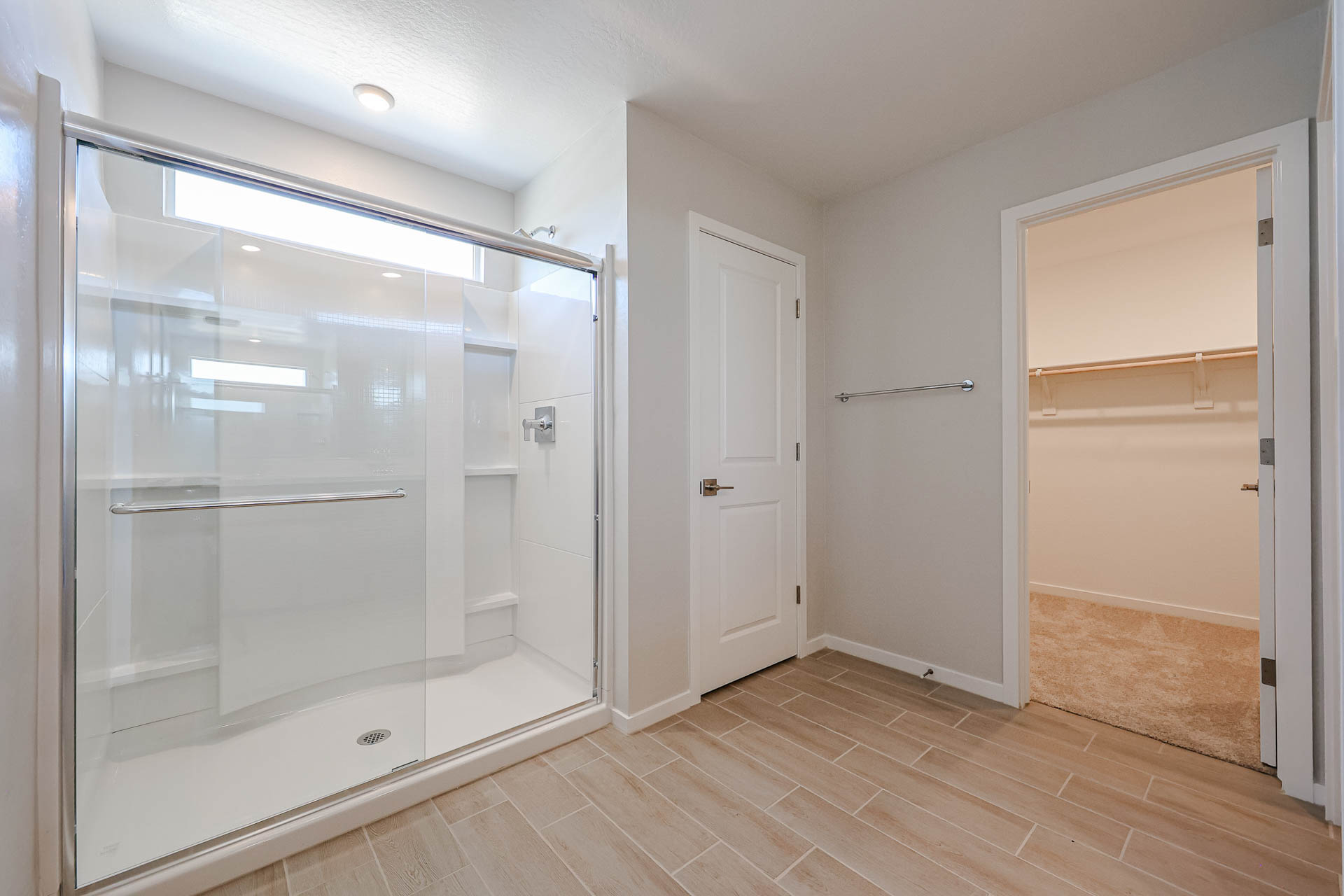 A room with a glass shower.