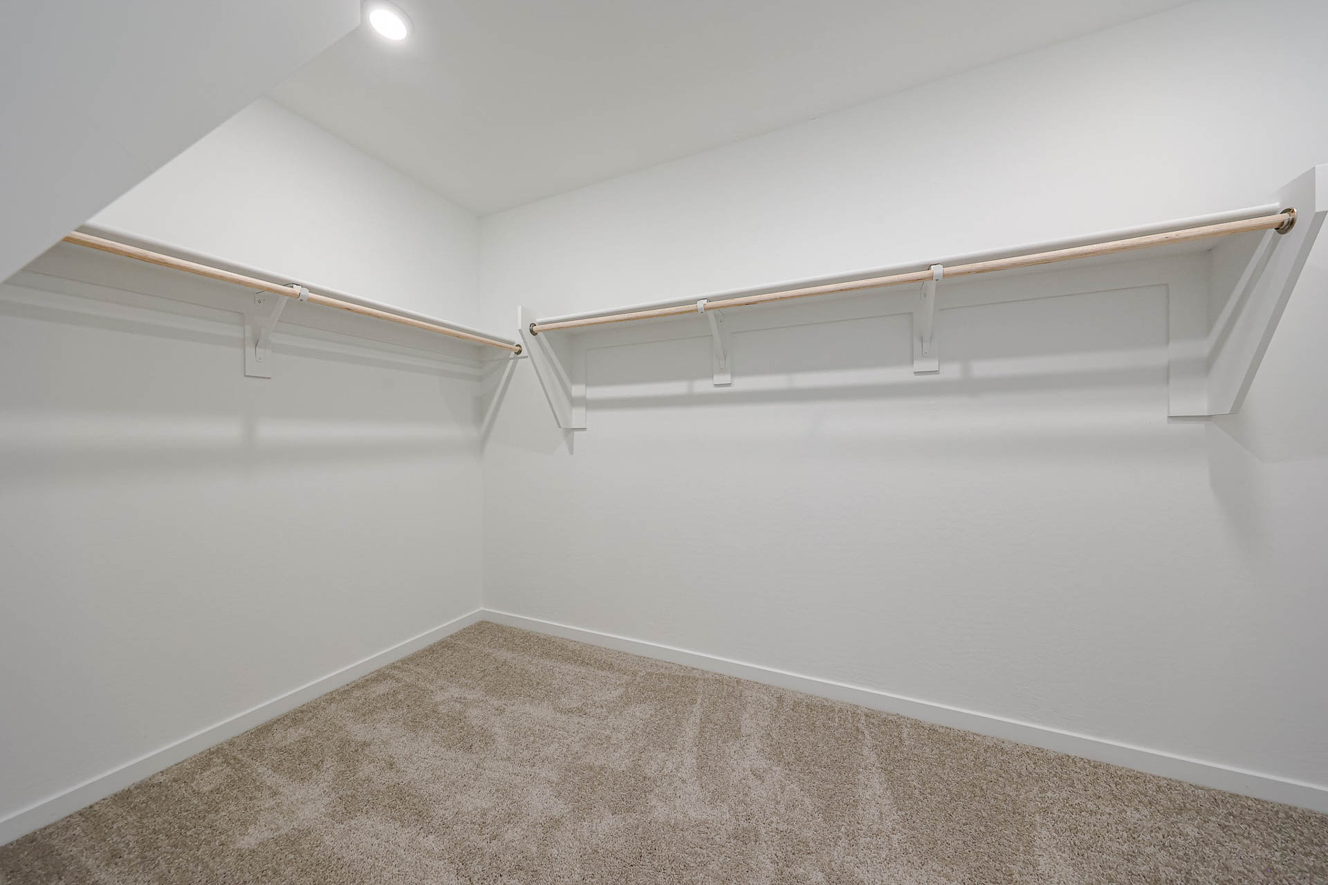 A white wall with a metal railing.