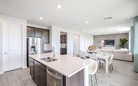A kitchen with white furniture.