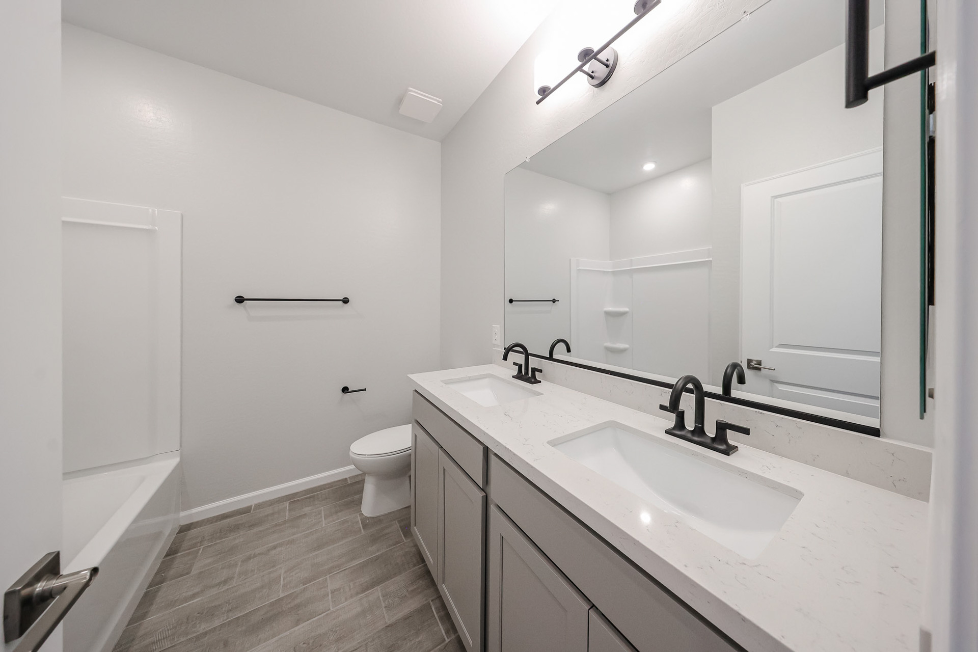 A bathroom with a large mirror.