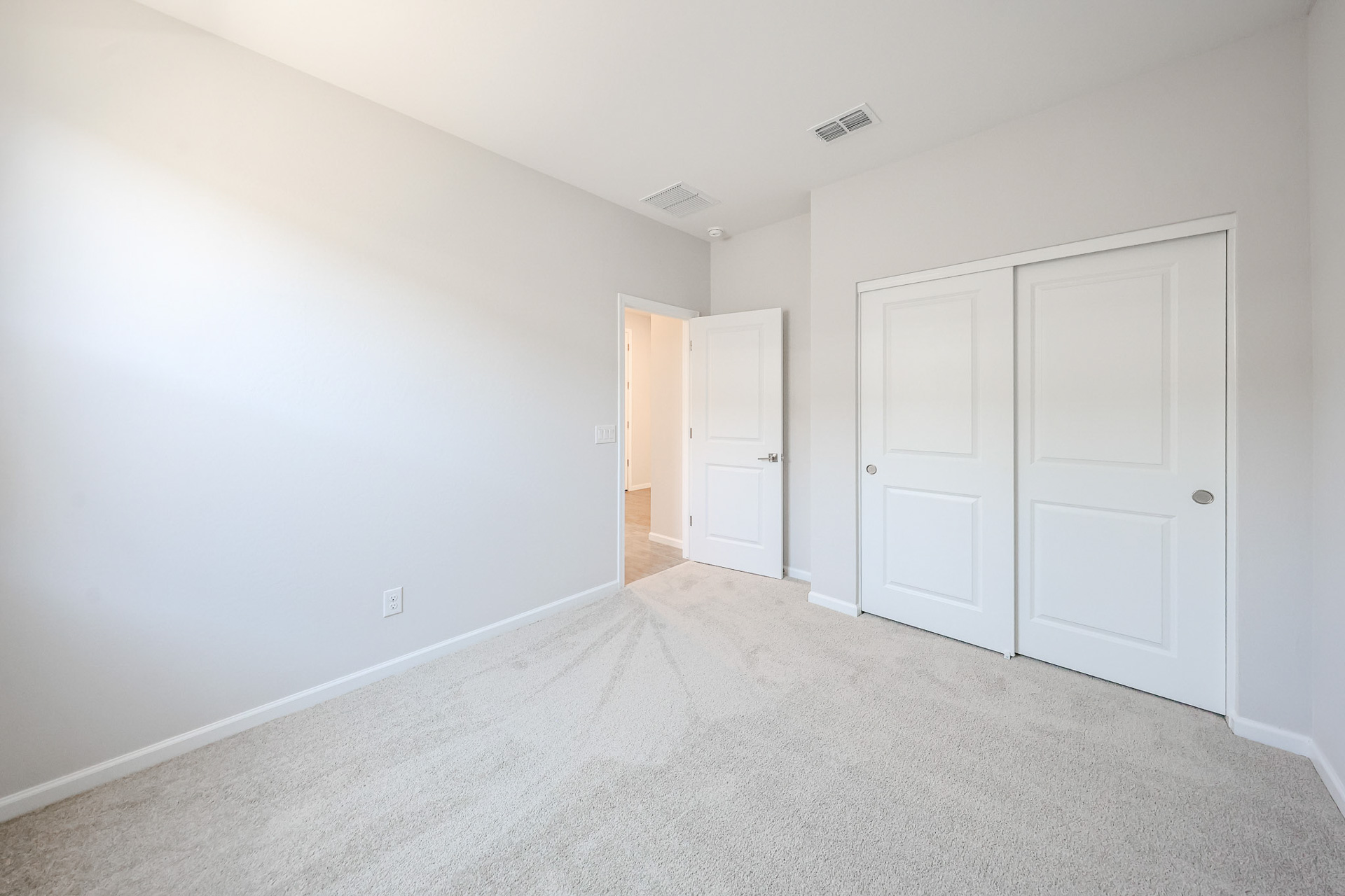 A hallway with white doors.