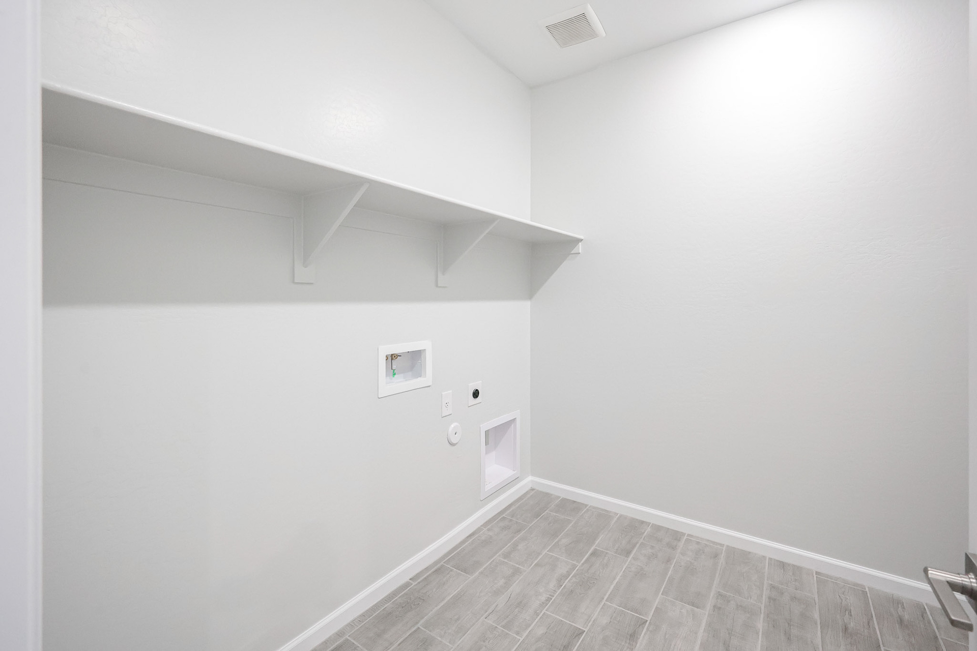 A white room with a tile floor.