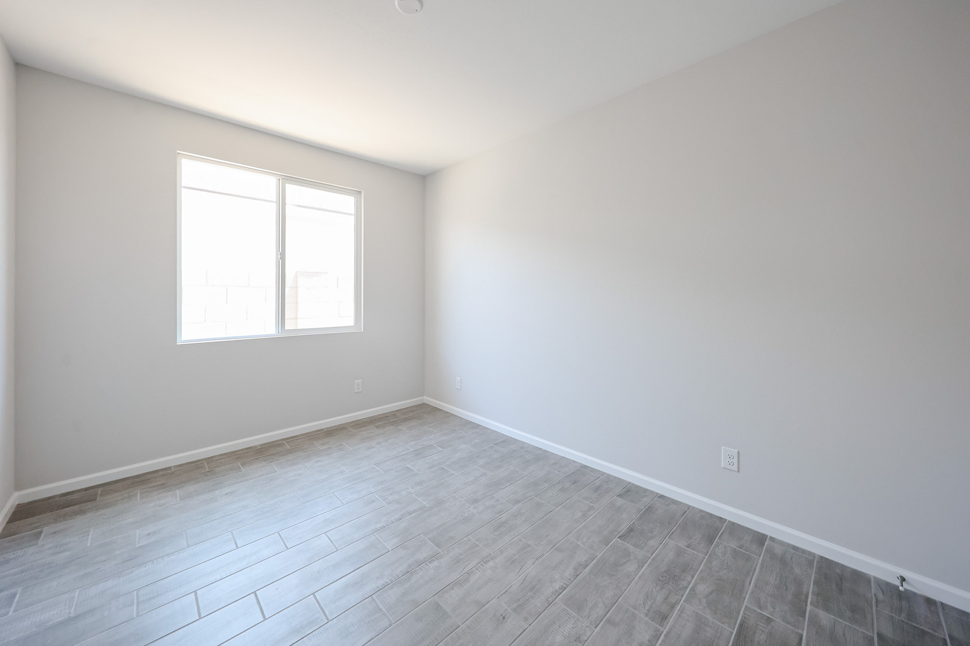 A room with a tile floor and windows.