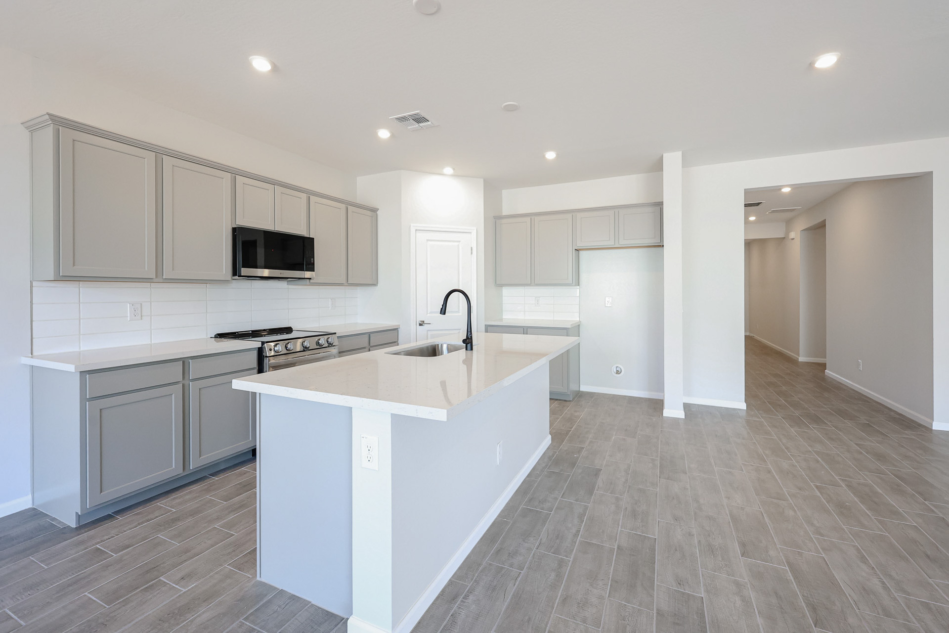 A kitchen with white cabinets.