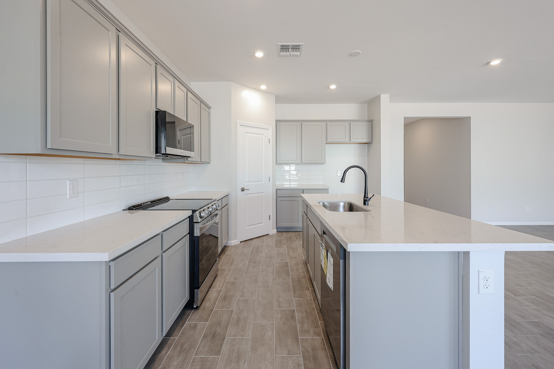 A kitchen with white cabinets.