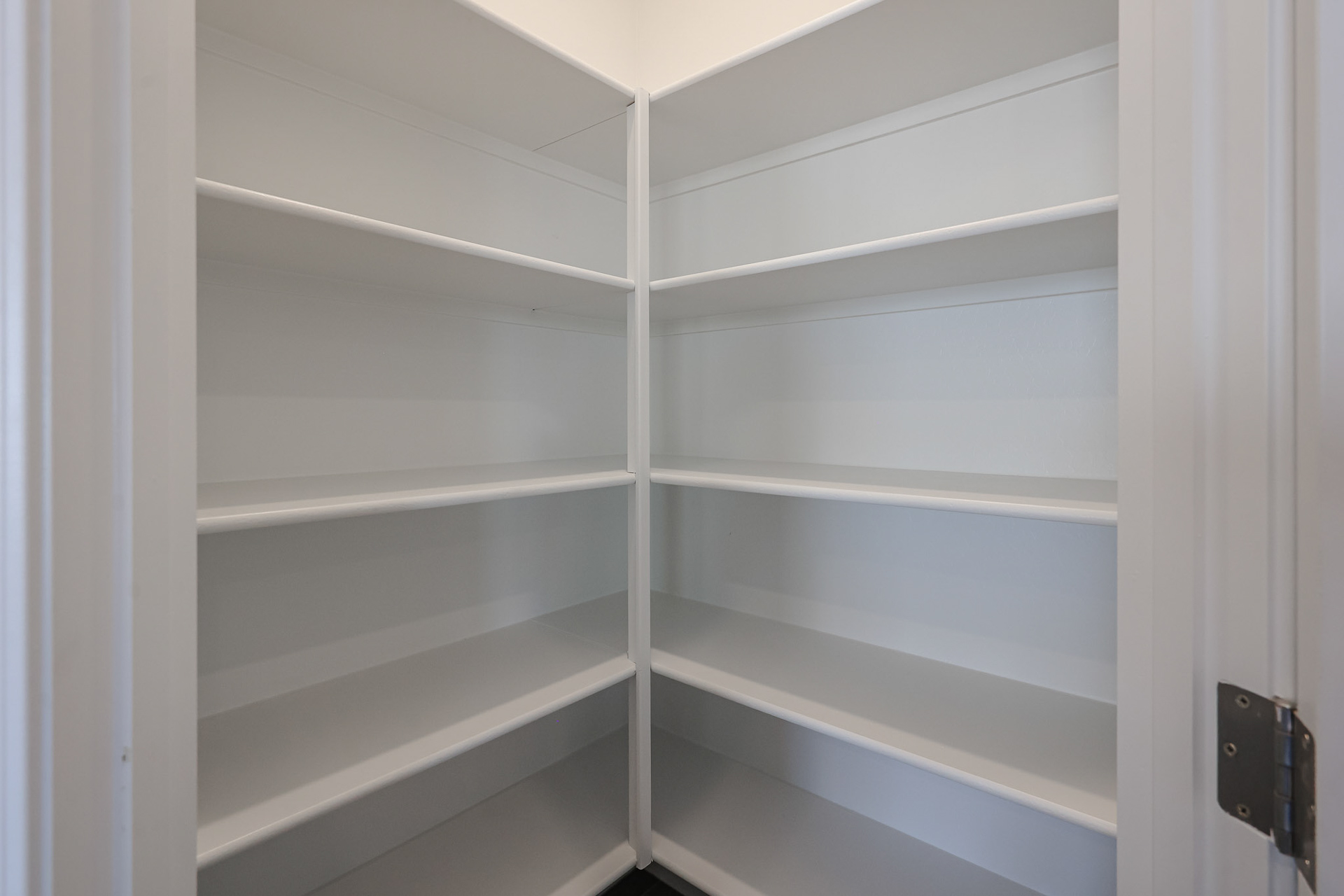 A white shelf with a door.