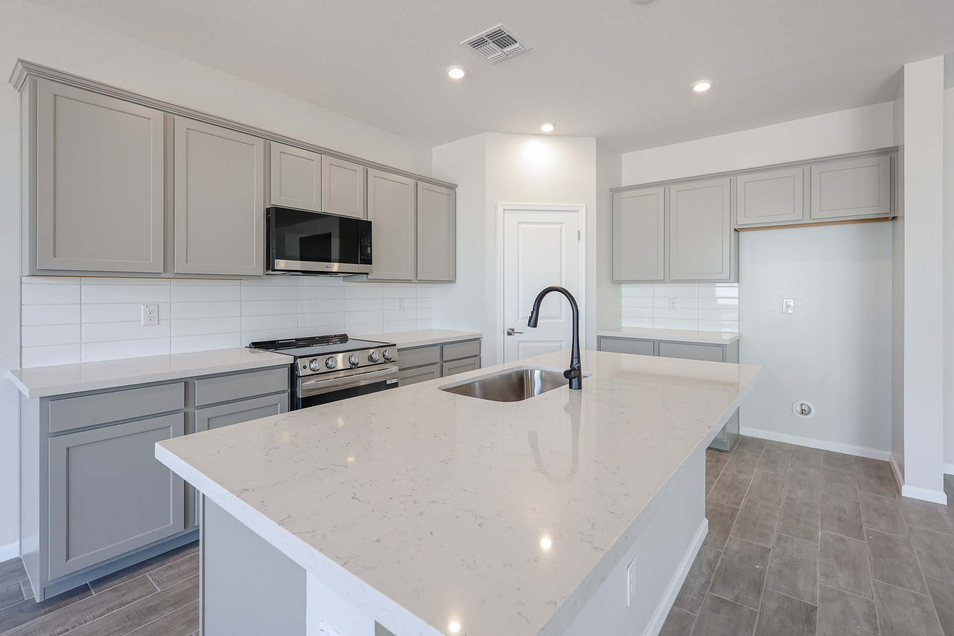 A kitchen with white cabinets.