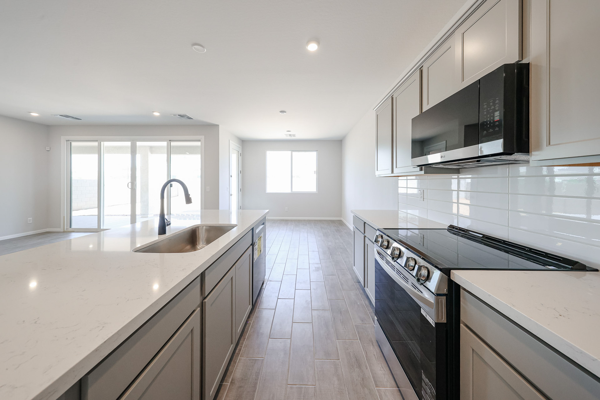 A kitchen with white cabinets.