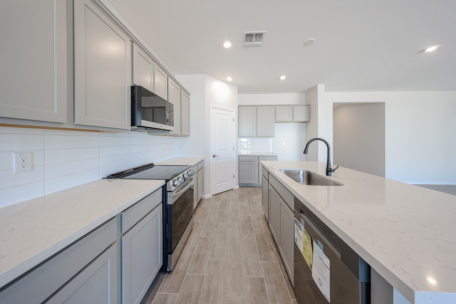 A kitchen with white cabinets.