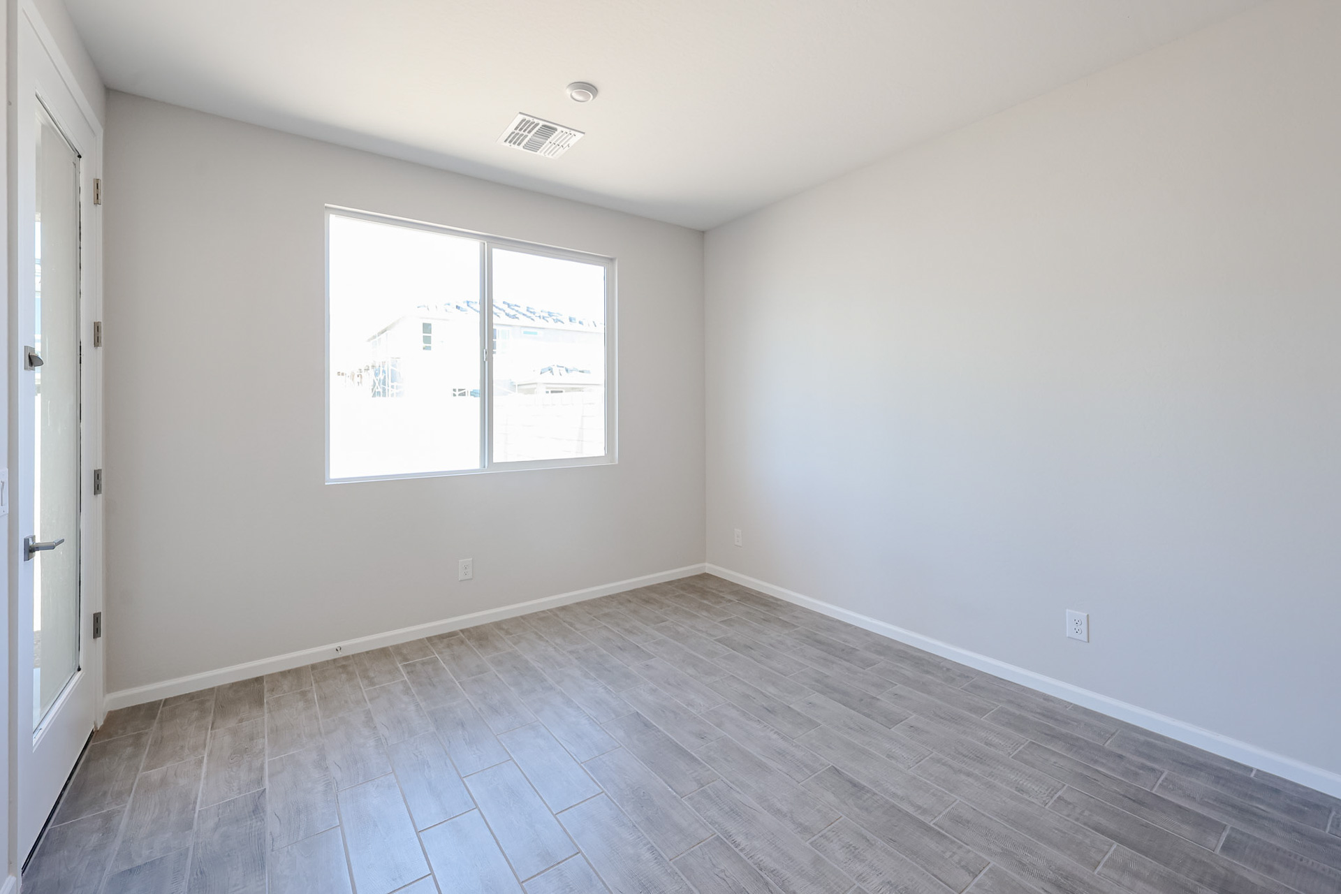 A room with a wood floor and white walls.