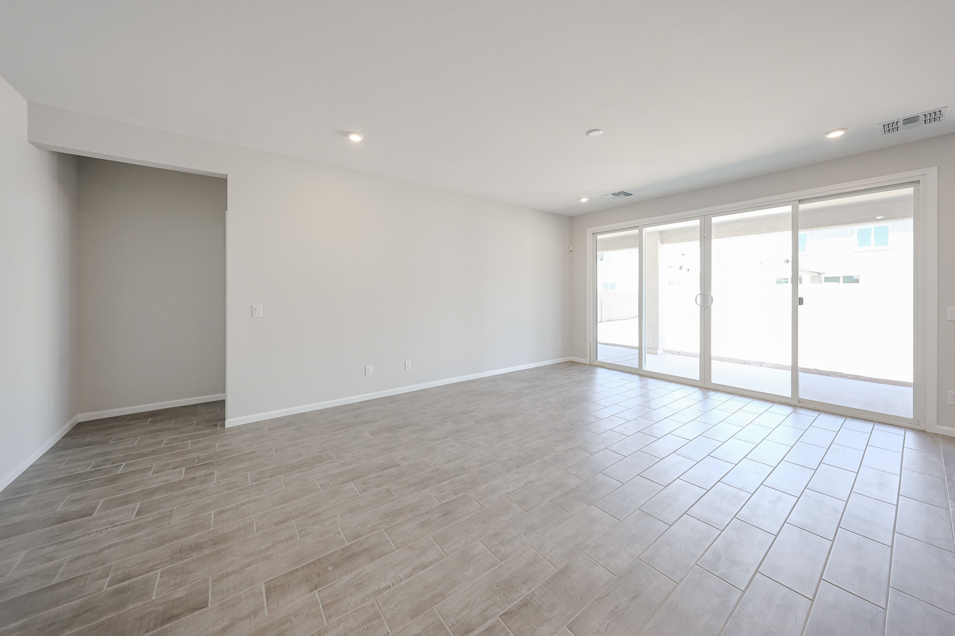 A room with white walls and a wood floor.