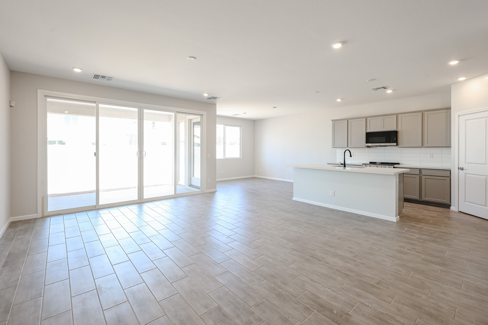 A large kitchen with white cabinets.