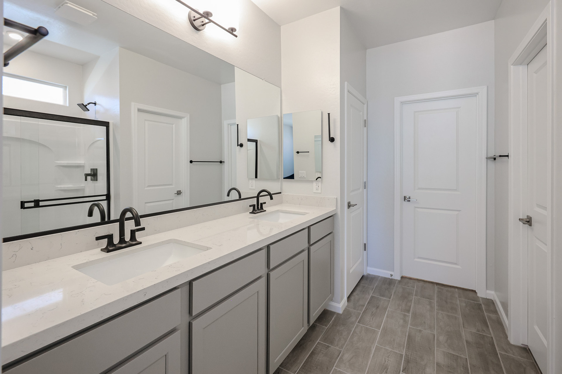 A bathroom with white cabinets.